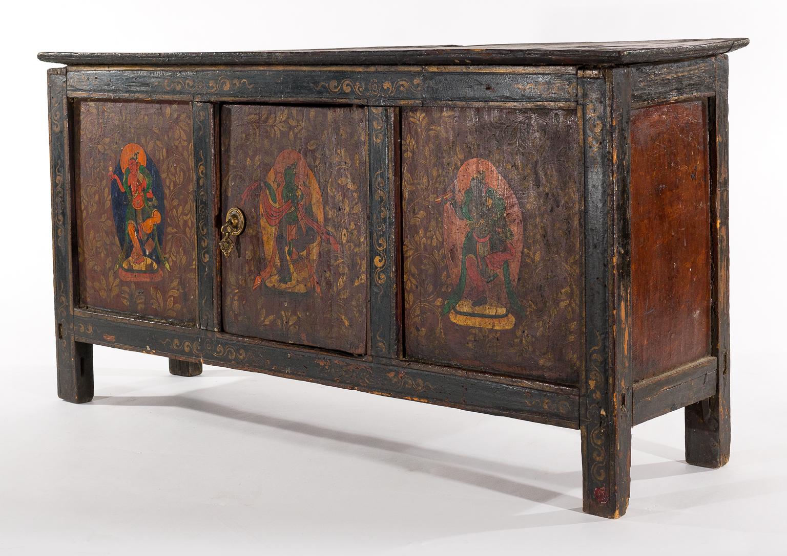 This antique table has incredible original antique painting on it depicting benevolent deities that represent wisdom and protection. This table was probably originally used in a monastery in Tibet possibly as part of an altar room. A very rare
