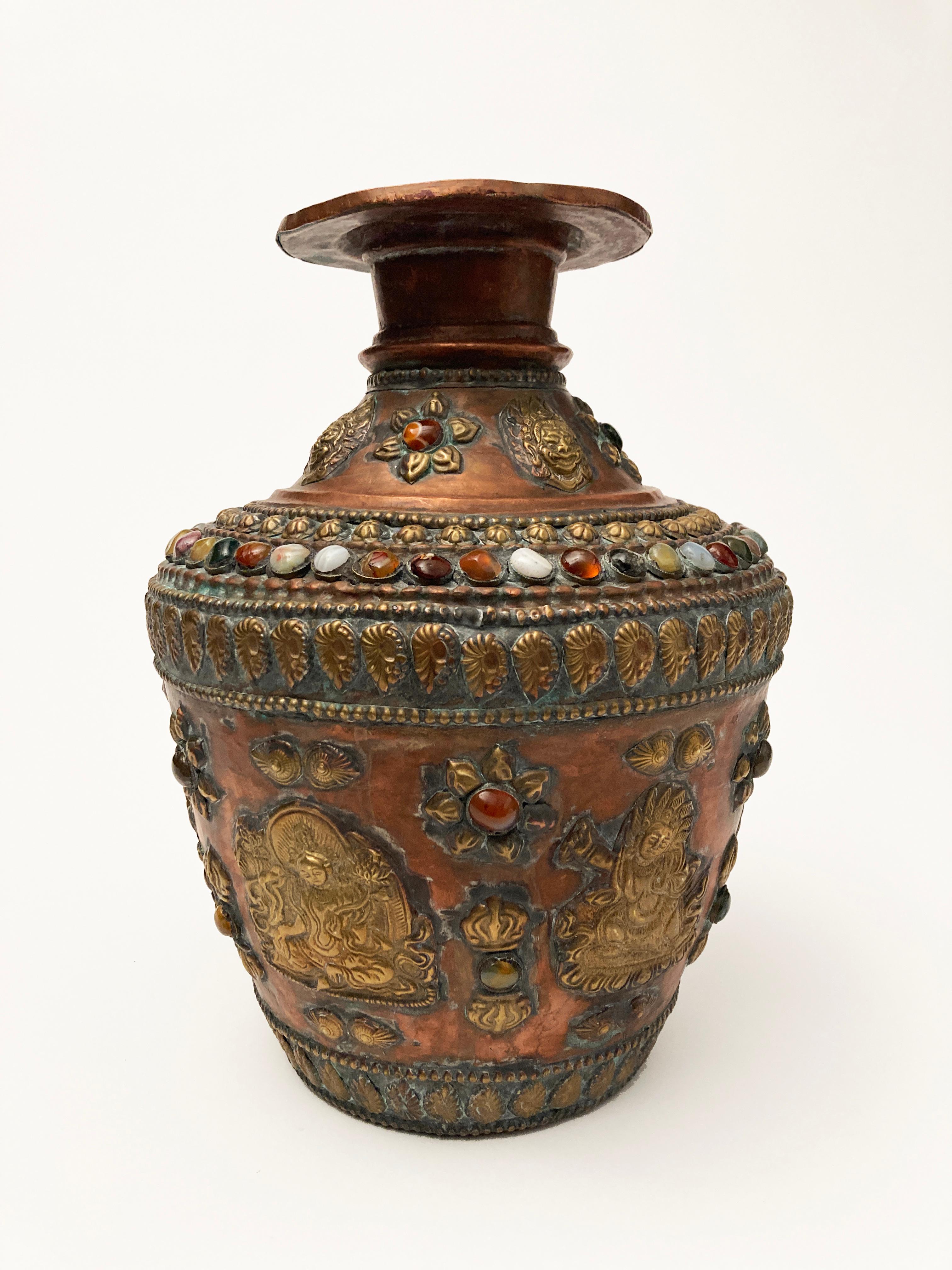 Copper vessels such as this have been made for literally centuries by Tibetan monks and other cultural sectors. The craftsmanship is wonderfully primitive with hammered copper, brass and bronze overall, yet portrays the intricacies of such