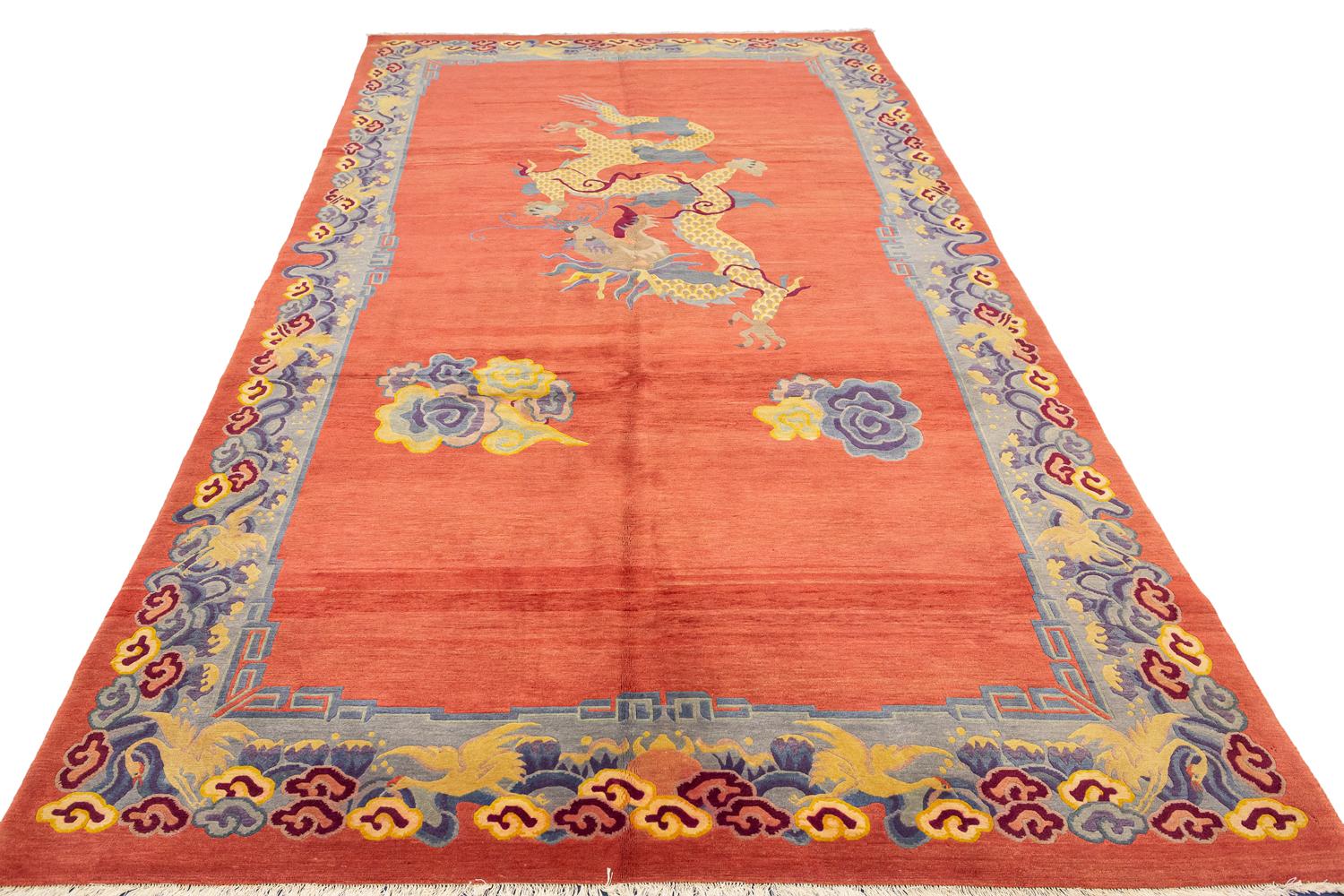 This is an antique Tibetan pictorial rug woven during the second quarter of the 20th century circa 1920-1950 and measures 320 x 175CM in size. The field depicts a dragon in midflight surrounded by two cloud motifs set on a read open field