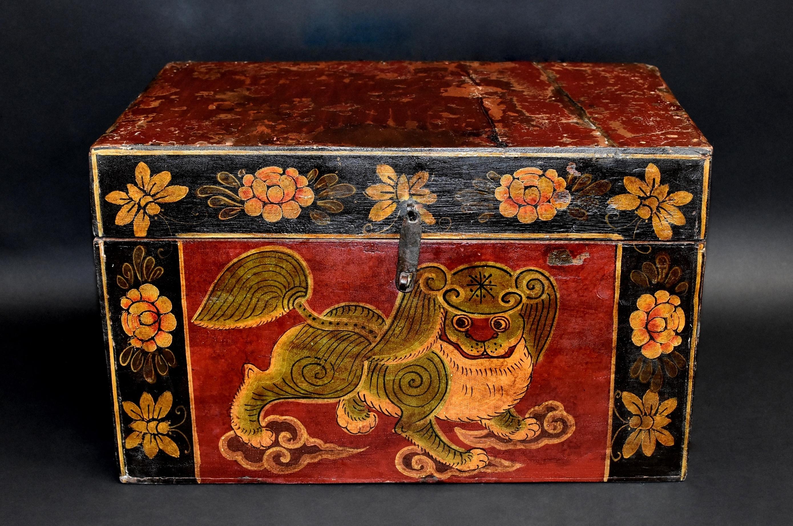 A wonderful, hand painted Tibetan box featuring a beautiful foo dog. The foo dog is of the Pekingese breed with perfect hair and posture. He looks to his right with great curiosity and intent. All four paws on clouds adds a celestial appeal. Border