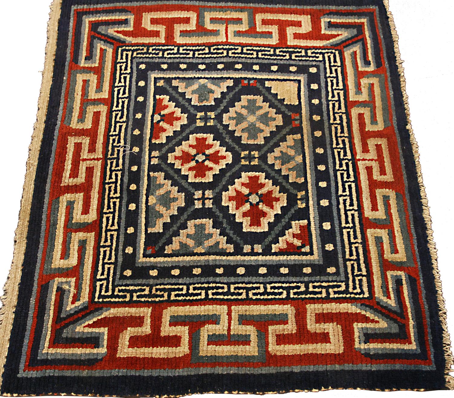 Hand-Knotted Antique Tibetan Geometric Design Wool Deep Blue Field Rug, ca. 1920 For Sale