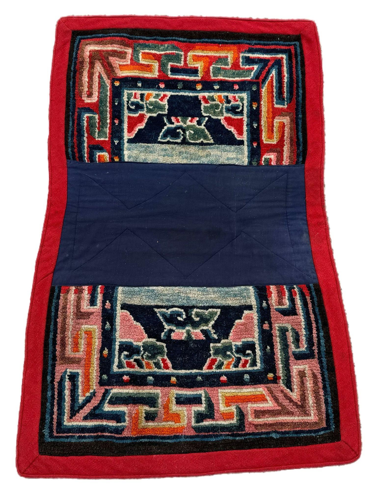 A fabulous antique horse cover, woven on the plains of Tibet in the early 20th Century. The design features stylised clouds on an indigo field surrounded by a distinctive key border. This rug would have been used to decorate a horse for special