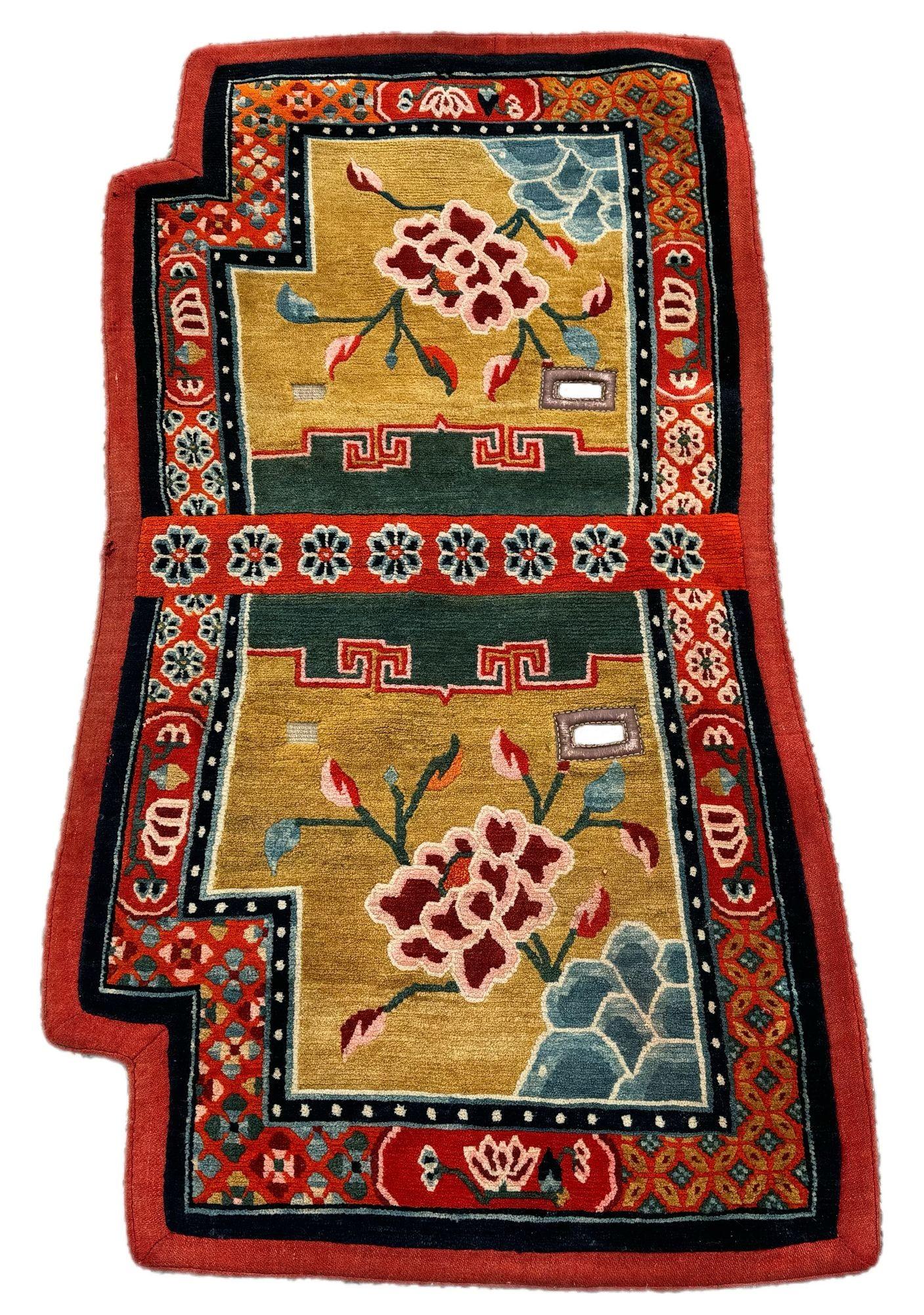 A fabulous antique horse cover, woven on the Tibetan plains in the early 20th Century. The design features a single large flower on an unusual gold field surrounded by a distinctive red border. This rug would have been used to decorate a horse for