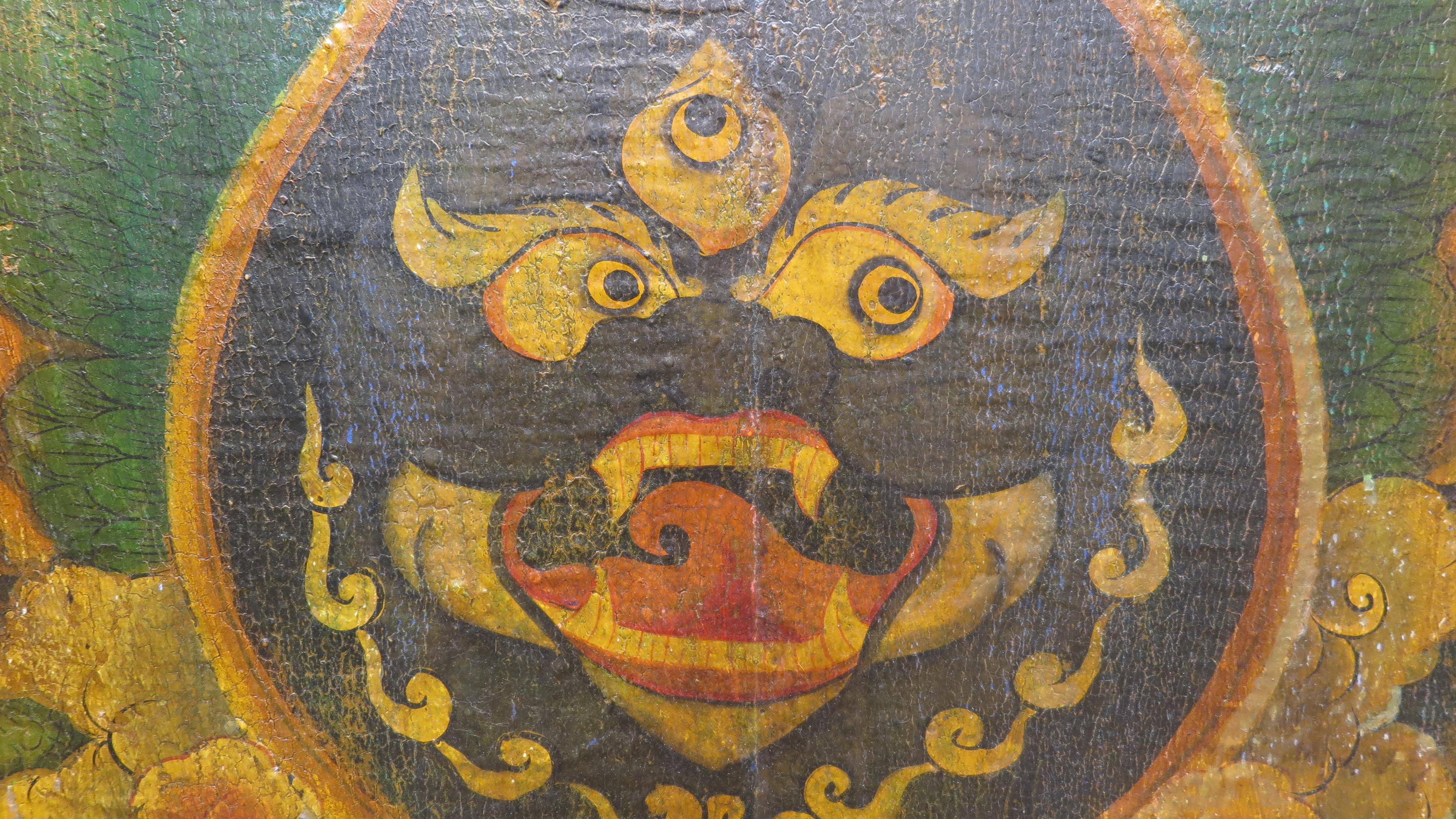 A Tibetan Painted Panel Door.  Canvas over wood painted using mineral pigments and polychrome.  Tibet has little resources and old wood is reused as platforms for Buddhist art.  This representation of the process of life creation showing a Mahakala