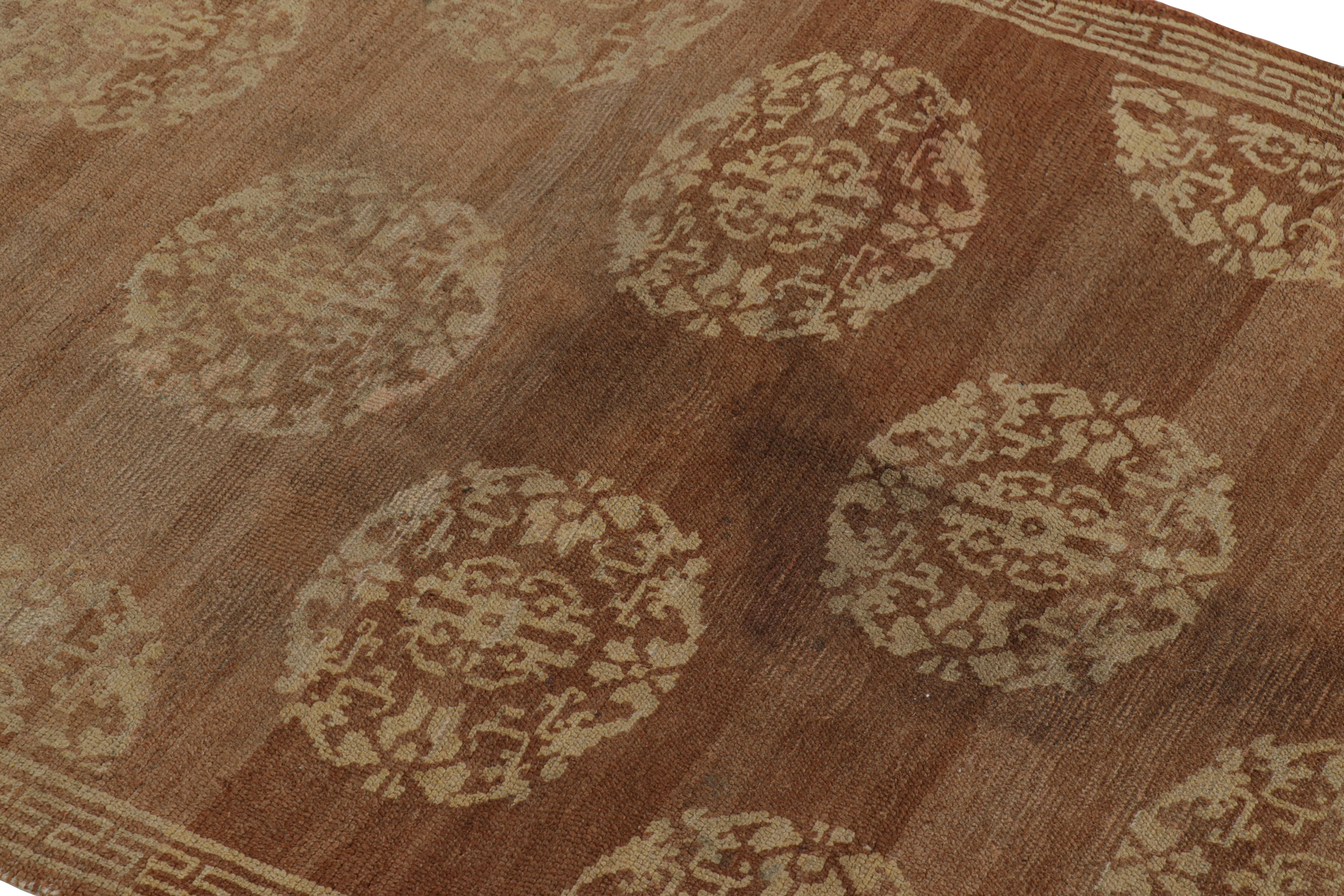 Hand-knotted in wool and hailing from Tibet circa 1920-1930, this 3x5 antique rug is a rich and collectible gift-sized Oriental rug with Art Deco-adjacent sensibilities and similarities to Khotan Samarkand rugs in its design. 

On the