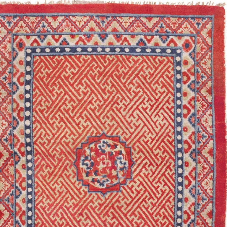 Tibetan rug, Tibet, early 20th century – Size: 4 ft 2 in x 5 ft 8 in (1.27 m x 1.73 m)

Rendered in a whimsical combination of ivory, vermillion and ultramarine blue, this charming antique rug from Tibet features elegant floral borders, a grand