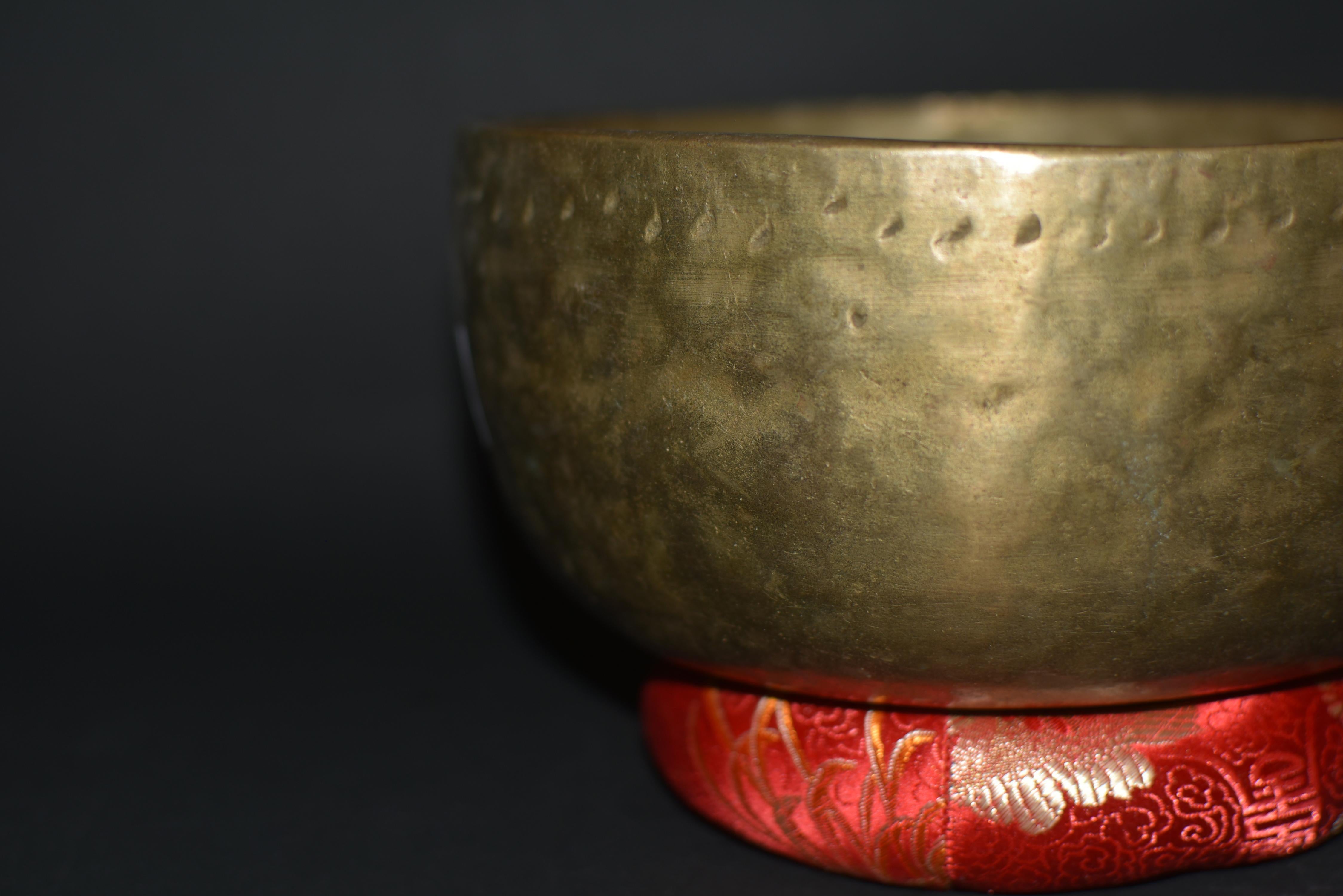 A beautiful, 19th century singing bowl from Bhutan. The hand made piece is free of extravagant decorations except a row of hand cut crescent motifs under the exterior rim. The crescent moon symbolizes clarity and modesty. A meaningful ceremonial