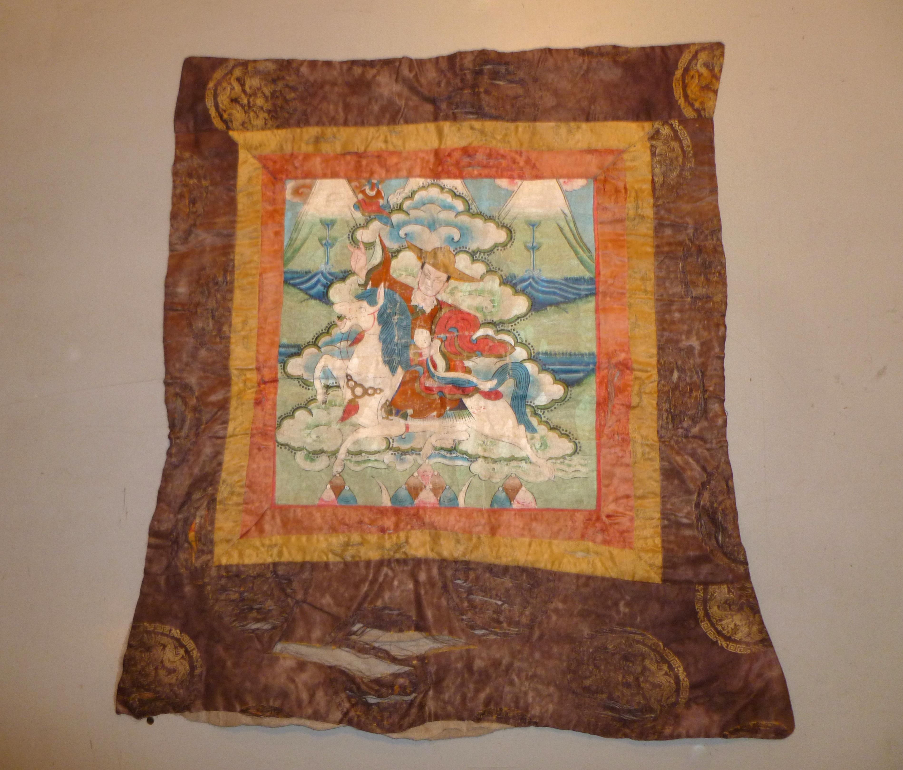 Antique Tibetan Thangka painted with horse rider in Mountain View
 Outside brown fabric with dragons style pattern
Overall size: 27' height.  23