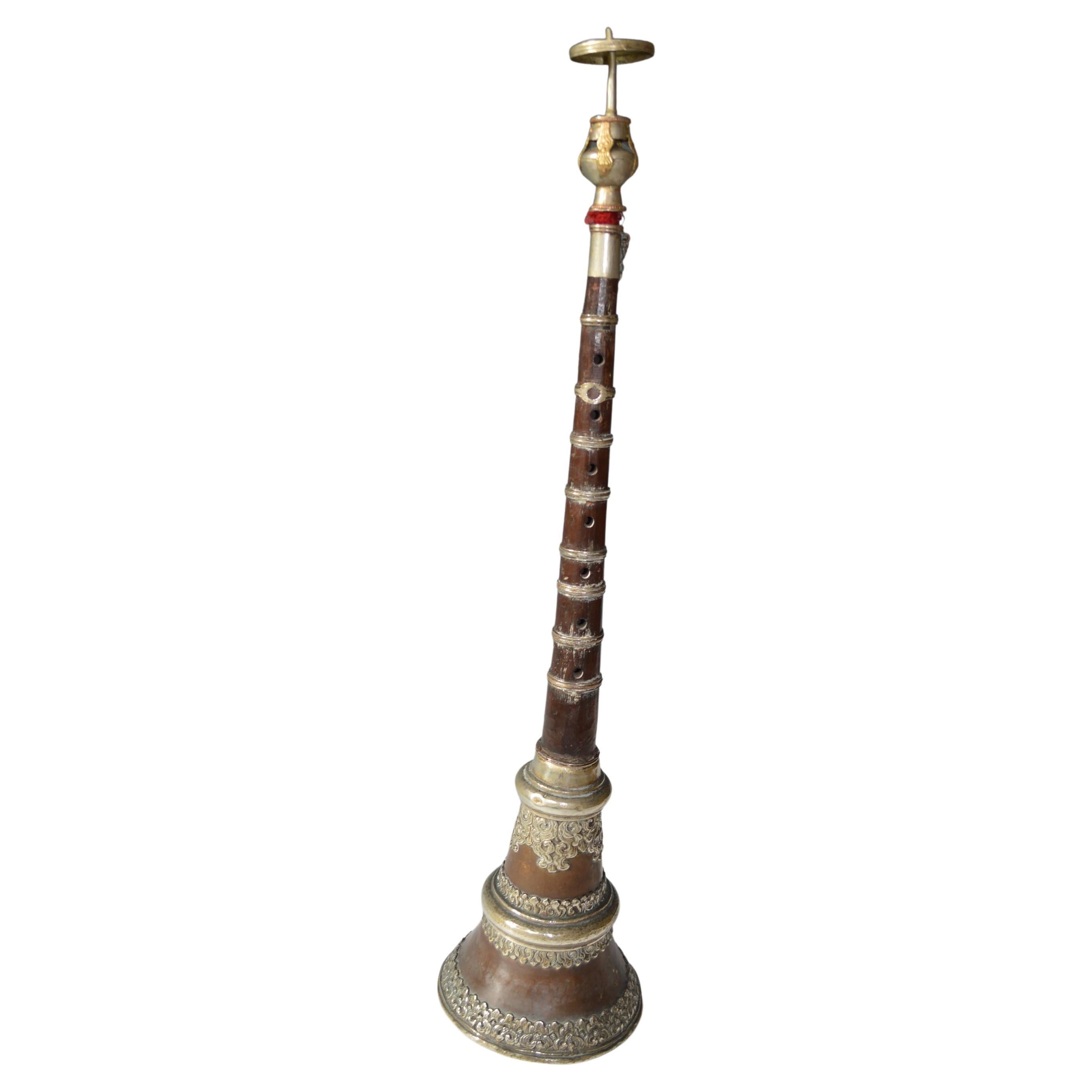  
A fine Antique Tibetan Buddhist Trumpet in copper with silver decoration with coral  Turquoise  
H 60 cm The the detachable mouth piece is a later replacement 
Condition : Good.