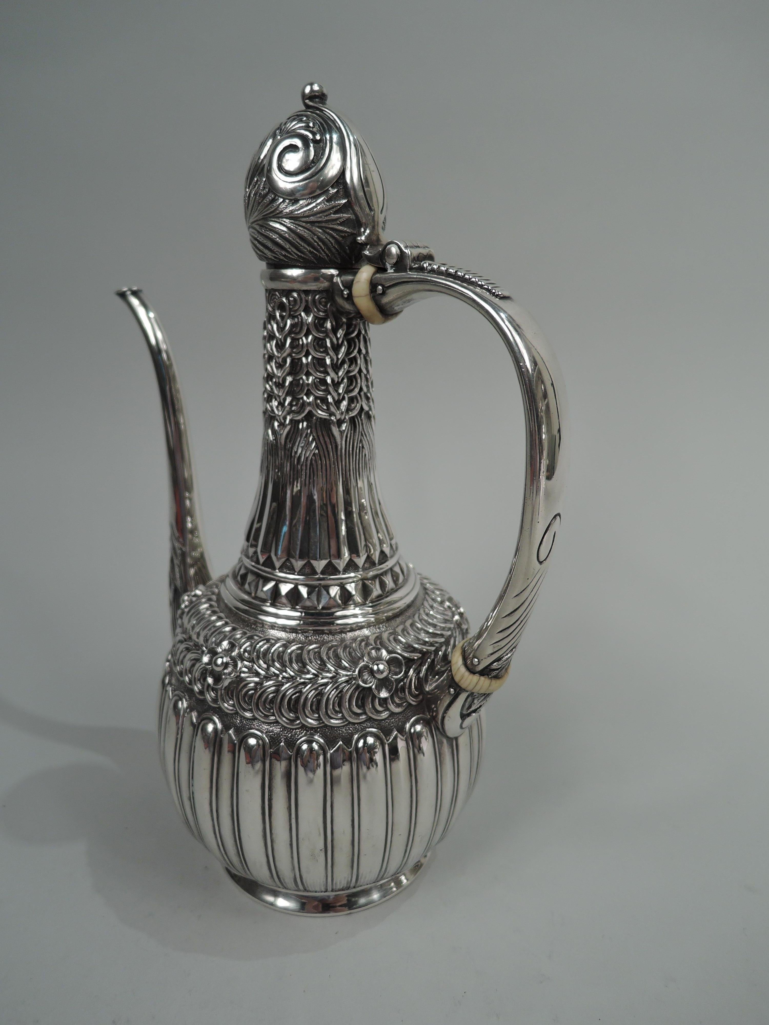 Aesthetic sterling silver Turkish coffeepot. Made by Tiffany & Co. in New York. Upward tapering neck and round bowl. Ball-cover hinge-mounted to c-scroll handle with applied ribbed thumb rest; vertical scrolled spout. Chased and embossed Classical