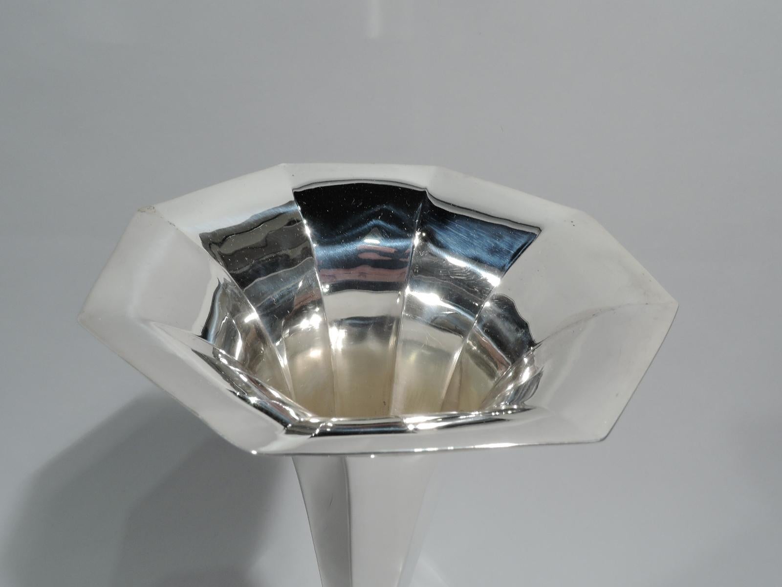 Art Deco sterling silver vase. Made by Tiffany & Co. in New York, ca 1912. Faceted cone with flared mouth and raised octagonal vase. Fully marked including maker’s stamp, pattern no. 18376 (first produced in 1912), and director’s letter m. Weighted.