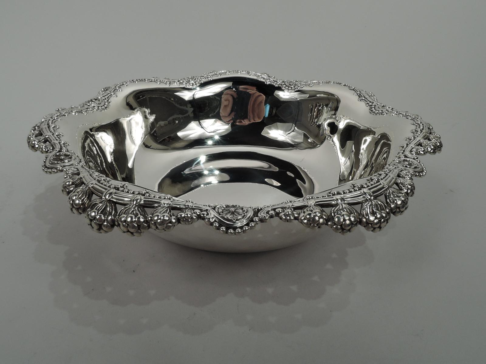 Art Nouveau sterling silver bowl. Made by Tiffany & Co. in New York, ca 1910. Curved and tapering sides and reeded and scalloped rim overhung with passementerie-style floral danglies. Beading and flower heads. Fully marked including maker’s stamp,