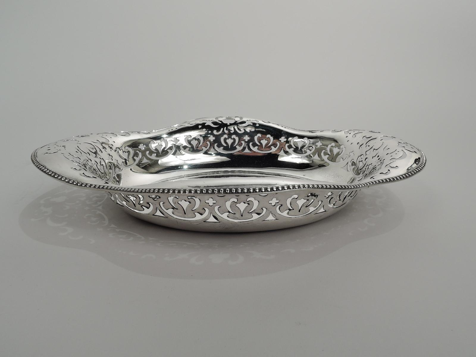 Edwardian sterling silver bowl. Made by Tiffany & Co. in New York, ca 1910. Solid oval well and lobed and beaded quatrefoil rim. Ornamental piercing. Fully marked including maker’s stamp, pattern no. 15827, and director’s letter m. Weight: 13.5 troy