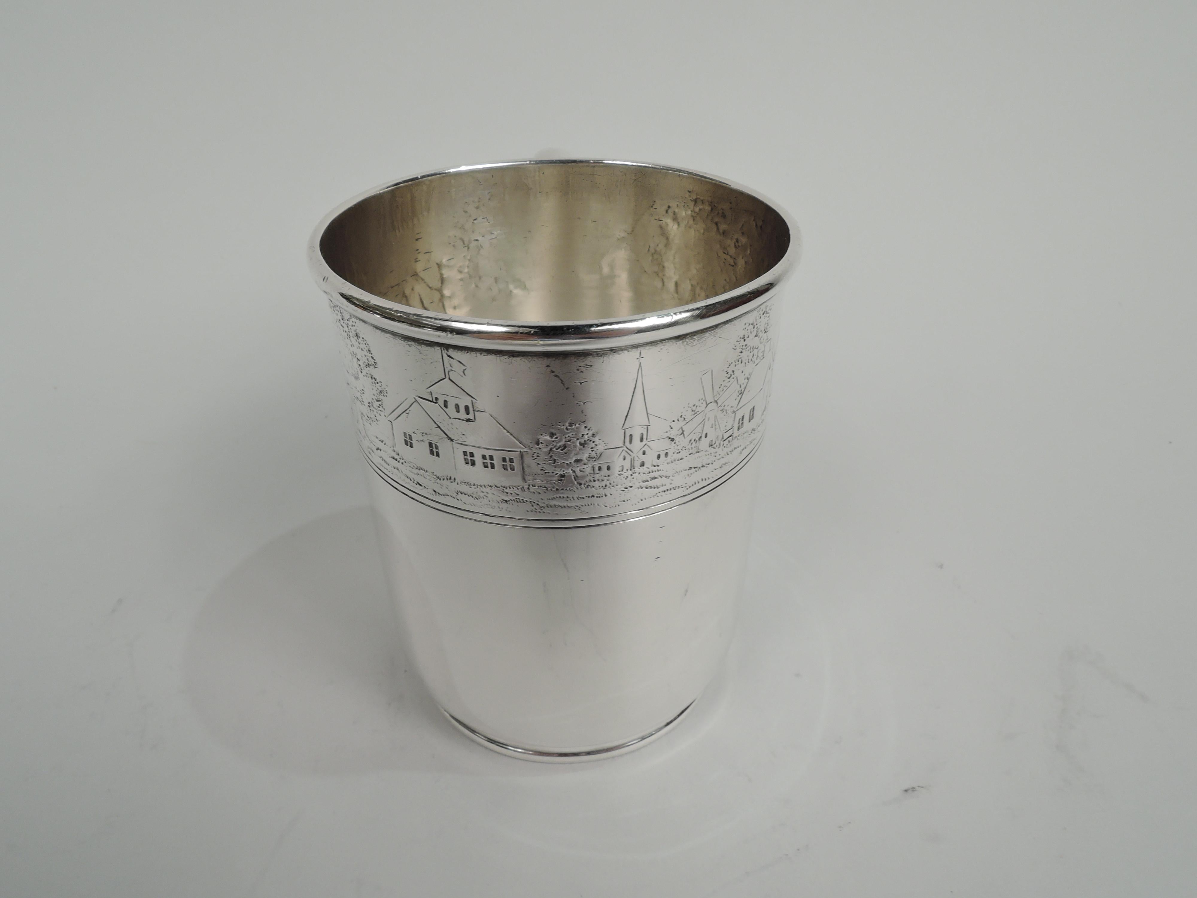 Edwardian sterling silver baby cup. Made by Tiffany & Co. in New York, ca 1909. Straight sides and curved bottom on short and inset foot; c-scroll handle. At top chased band with pastoral landscape: A herdsman follows the cows who amble in the