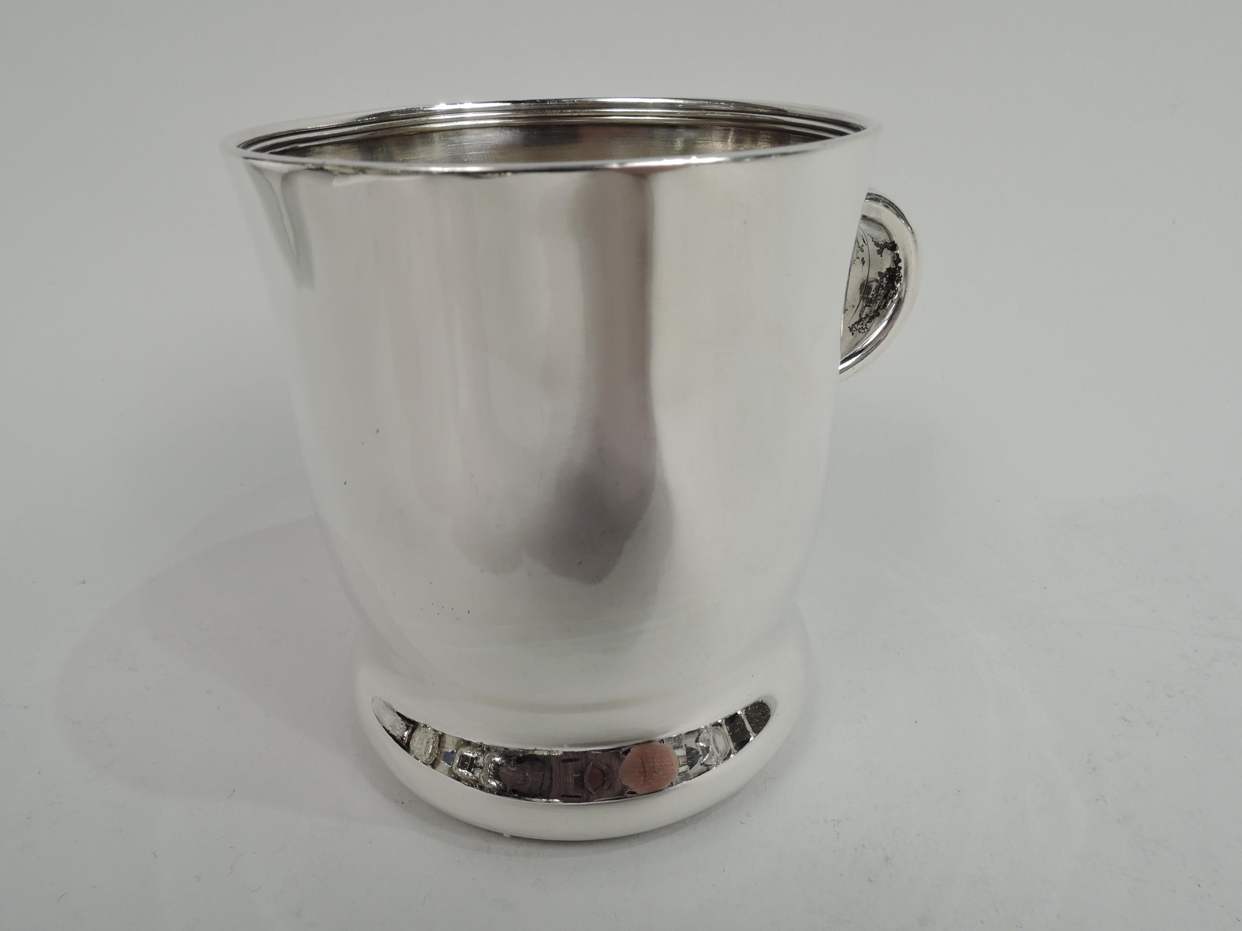 Victorian Classical sterling silver baby cup. Made by Tiffany & Co. in New York. Gently curved sides and concave bottom. Small c-scroll handle with outsized leaf mounts. Lots of room for engraving. Fully marked including maker’s stamp, pattern no.