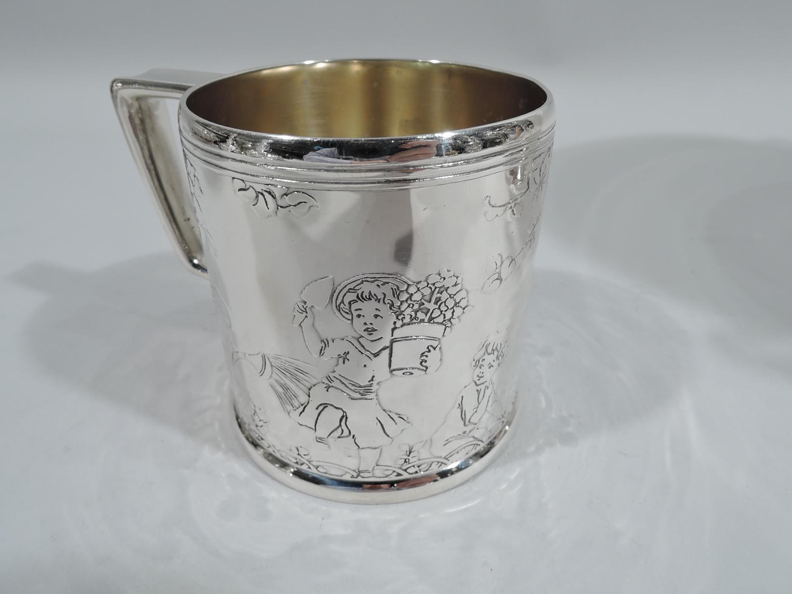 Art Deco sterling silver baby cup. Made by Tiffany & Co. in New York, ca 1927. Gently upward tapering sides and bracket handle. Acid-etched frieze depicting child gardeners lugging water cans and pushing wheelbarrows. Front vacant for engraving the