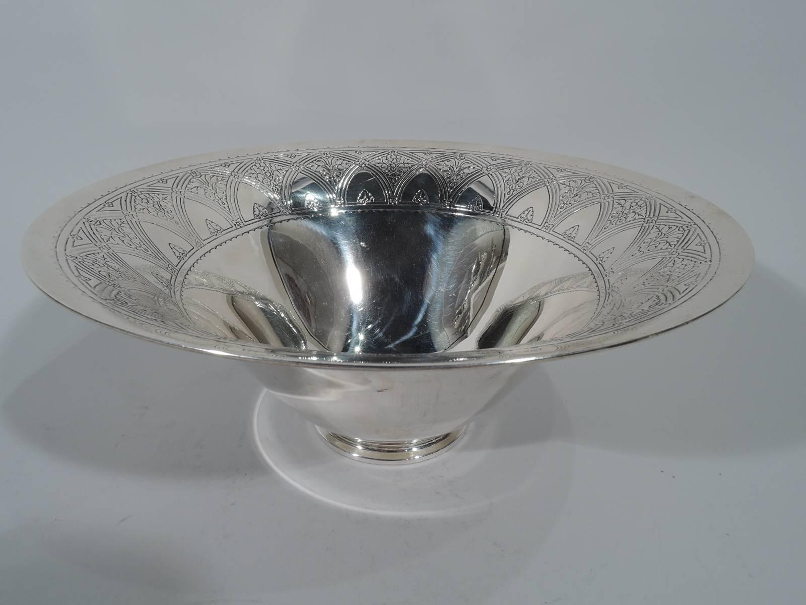 Art Deco sterling silver centrepiece bowl. Made by Tiffany & Co. in New York, circa 1924. Wide mouth, steeply tapering sides, and stepped foot. Interior has acid-etched interlaced arcade inset with flowers and scalloped border. A semi-abstract