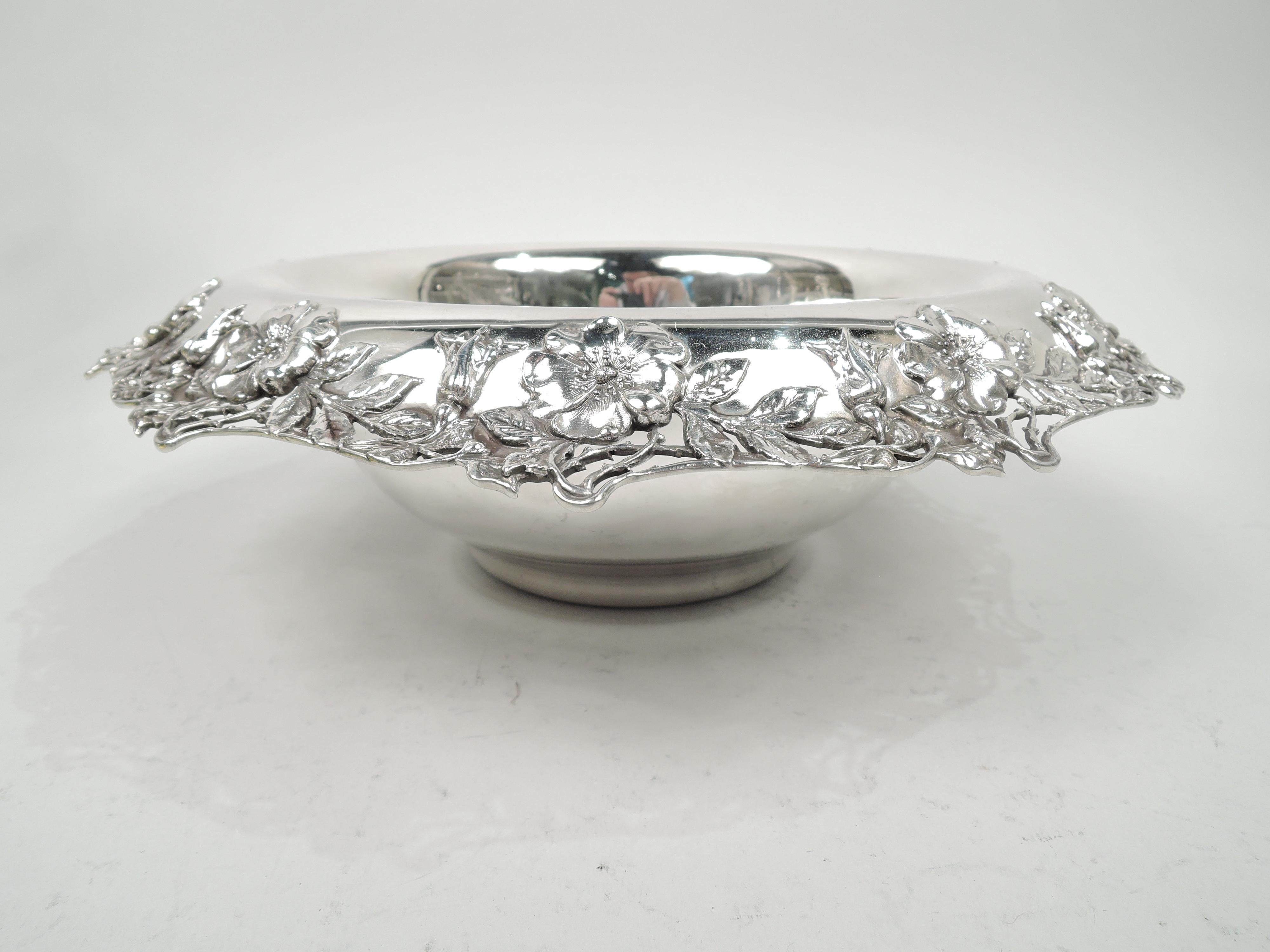 Art Nouveau sterling silver bowl. Round with curved sides and inset foot. Made by Tiffany & Co. in New York, circa 1910. Rim turned-down with applied and open blossoming branches. Fresh and pretty from the turn of the last century. Fully marked