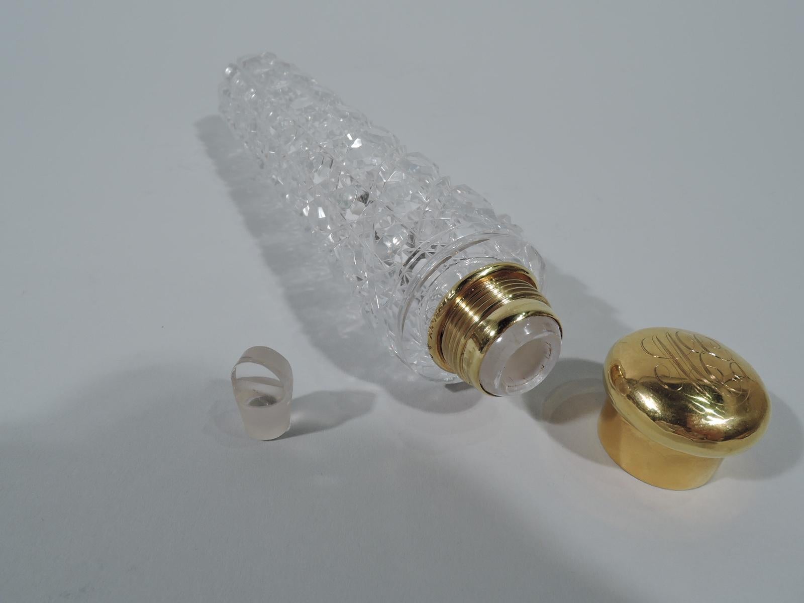 American brilliant-cut-glass and 18-karat gold perfume vial. Made by Tiffany & Co. in New York, circa 1900. Tubular with square grid. Ornament comprises faceted X’s alternating with faceted rondels. Short neck with gold collar and threaded cover