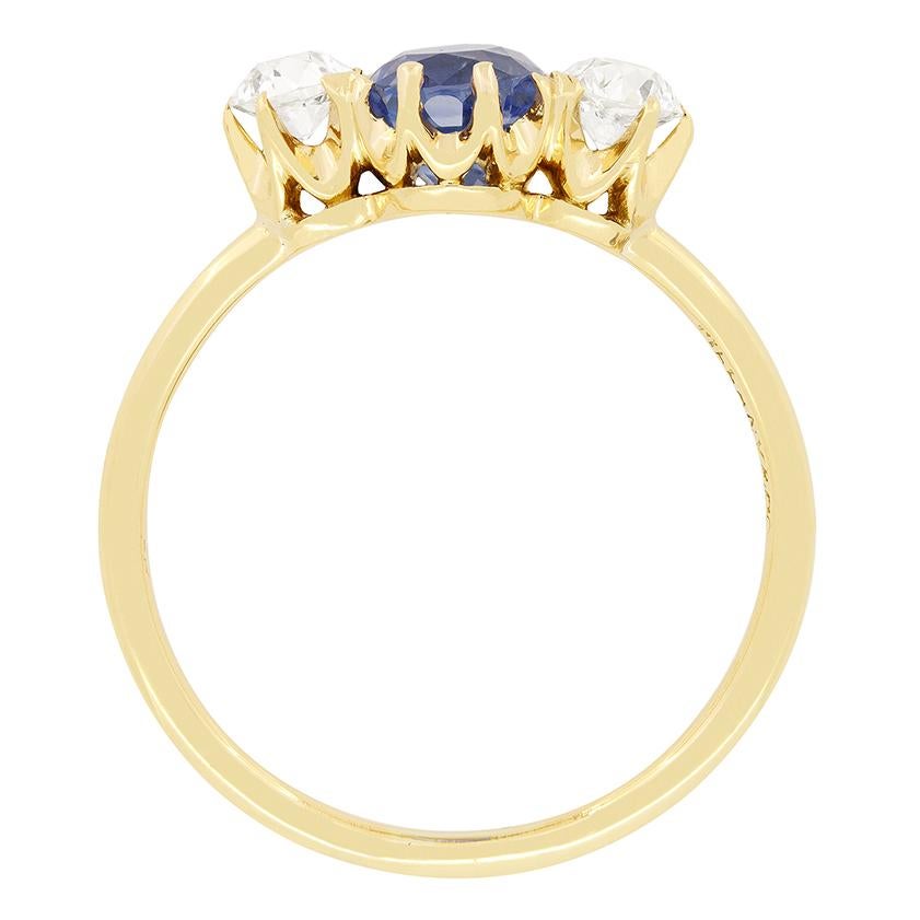 This classic trilogy ring comes from the makers Tiffany & Co. Crafted in the 1900s this beautiful ring features a central sapphire flanked by old cut diamonds. The 1.20 carat Sapphire is Ceylon in origin, and is completely natural and unheated. The