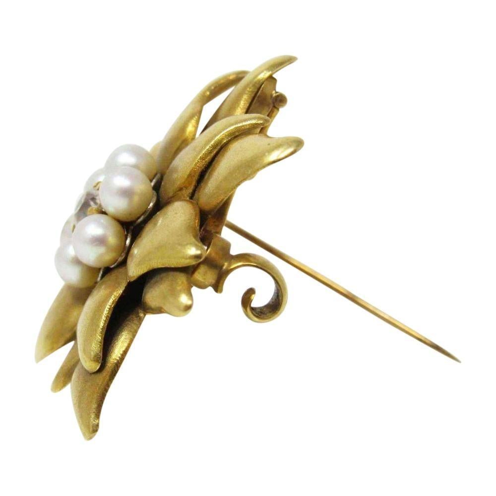 Versatile Tiffany & Company diamond and pearl pendant or brooch
Dimensional floral form
18k yellow gold
6 pearls and 1 old mine cut diamond
Circa 1890
Measurements: 1 1/4” in diameter.  
Weight: 12.2 grams
Feminine, Classic
Stock Number: WE-249