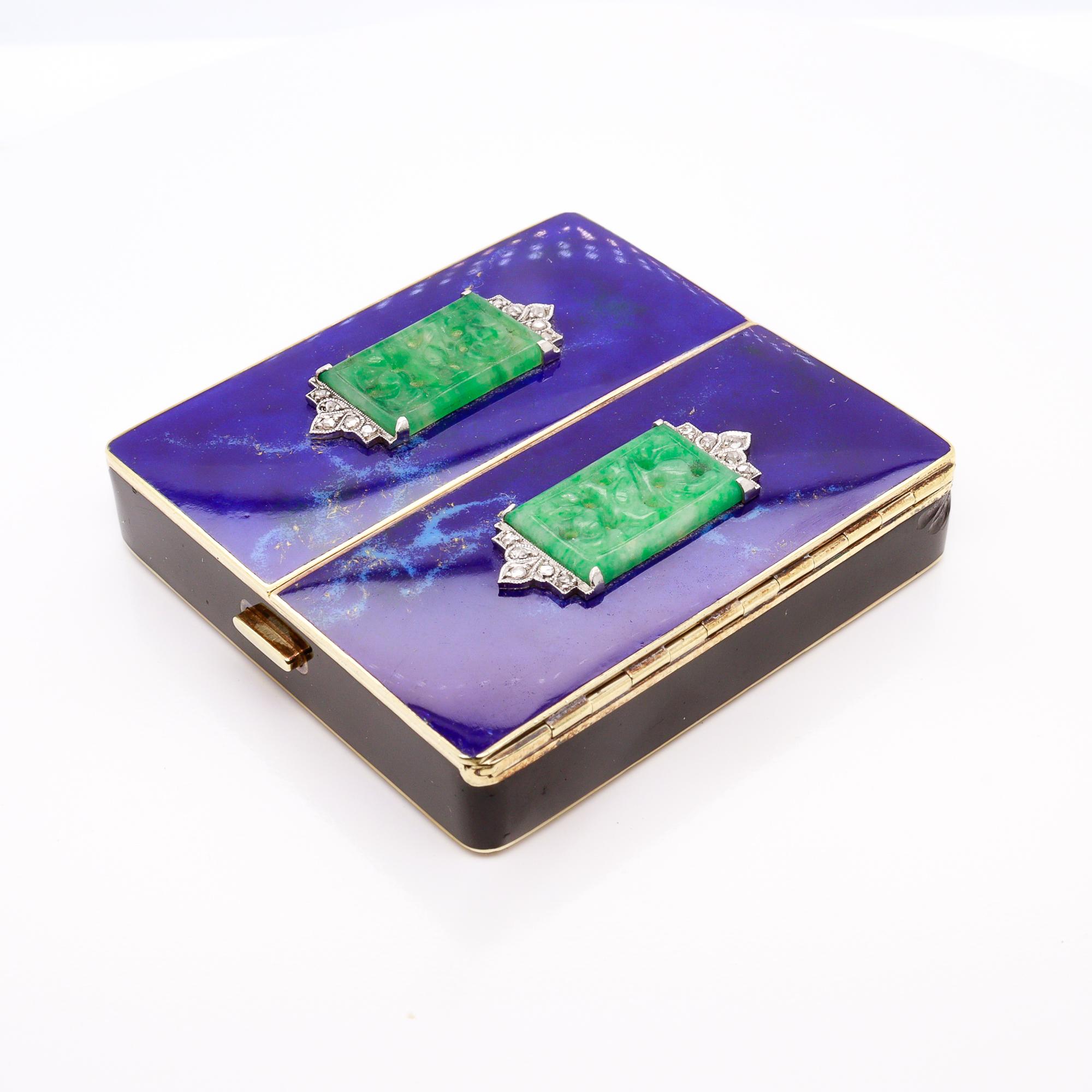 A fine antique Art Deco gold and enamel powder compact. 

By Tiffany & Co. 

In 14k yellow gold.

With a marbled, blue enamel underside and a black enamel central band. The top with a pair of marbled blue enamel, hinged covers set with carved,