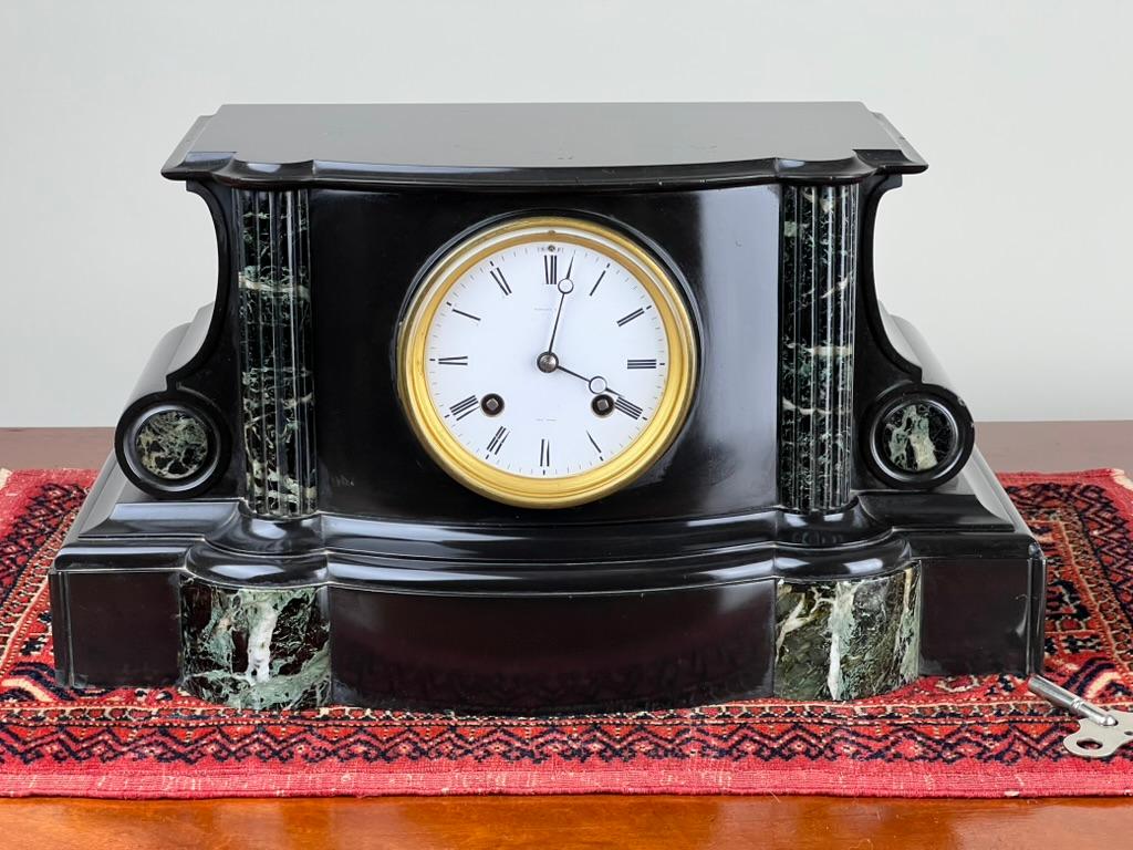 A striking presence on any mantle or sideboard, this Antique Tiffany & Co. Time and Strike Mantle Clock dates to the early 1900s and showcases the refined craftsmanship and elegant materials that defined turn-of-the-century luxury. The sculptural