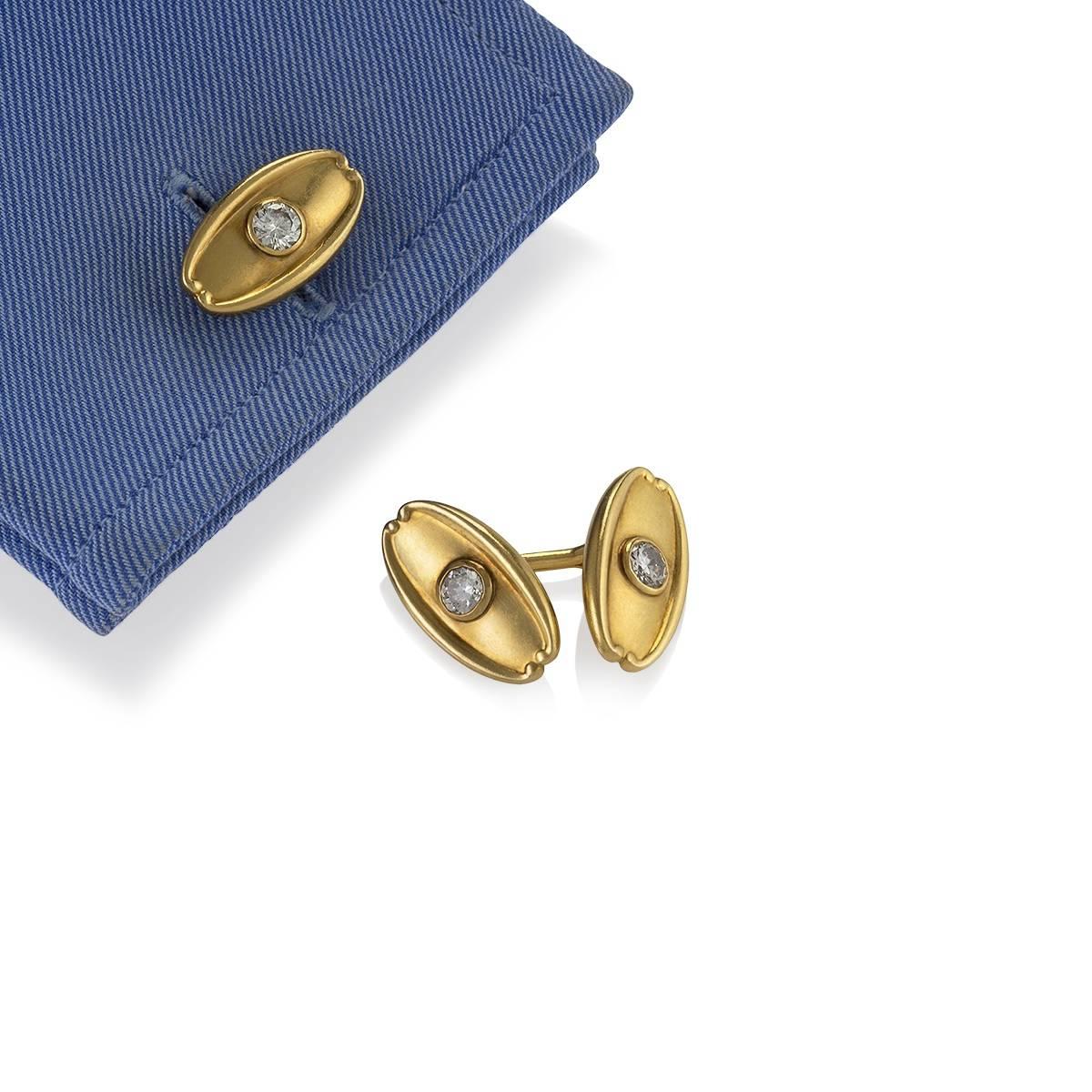 A pair of Antique 18 karat gold cuff links with diamonds by Tiffany & Co. The heavy, lozenge-shaped cuff links have 4 old European-cut diamonds with an approximate total weight of 1.50 carat, H-I color, VS clarity.  Double-sided. With later, signed,