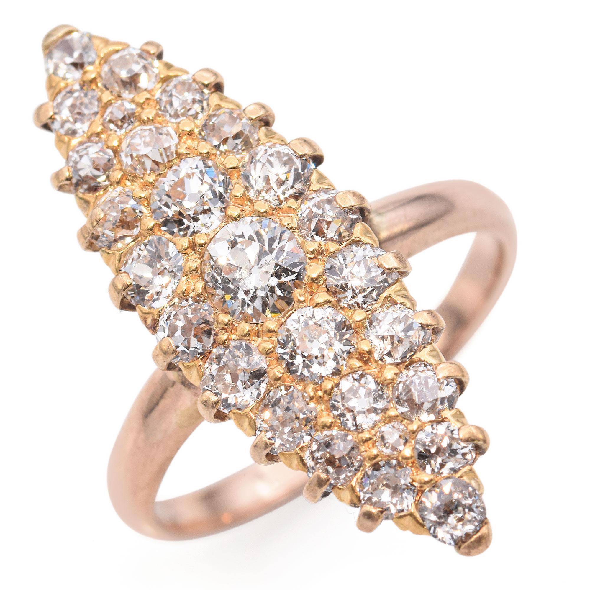 This exquisite ring is crafted in a warm gold setting by Tiffany and Co. It features a stunning array of round brilliant-cut diamonds meticulously arranged in a marquise shape. The diamonds are set in a raised cluster, creating a dazzling display of