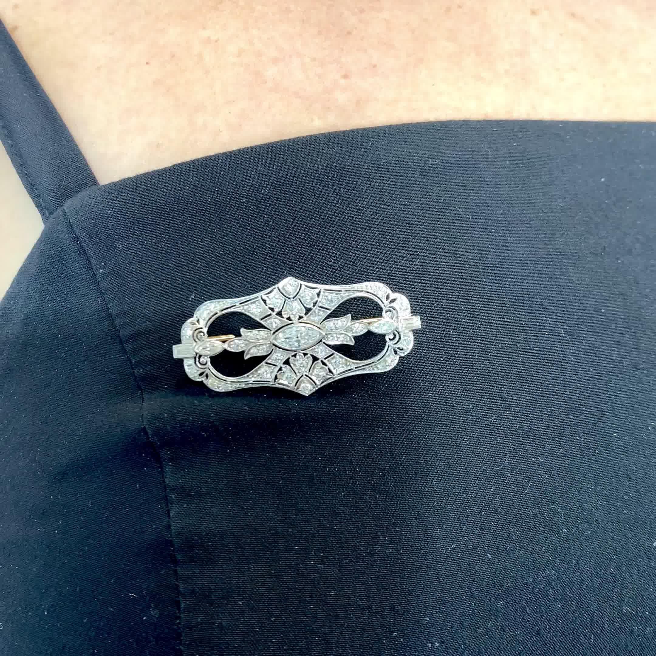 Antique Tiffany & Co. Diamond Platinum Brooch.The brooch features a marquise cut diamond approximately 0.35 carat, E color, VS+ clarity. Accented by 2 marquise, 2 baguettes,  38 OEC approximately 0.90 carat, H-I color average. Signed Tiffany & Co.