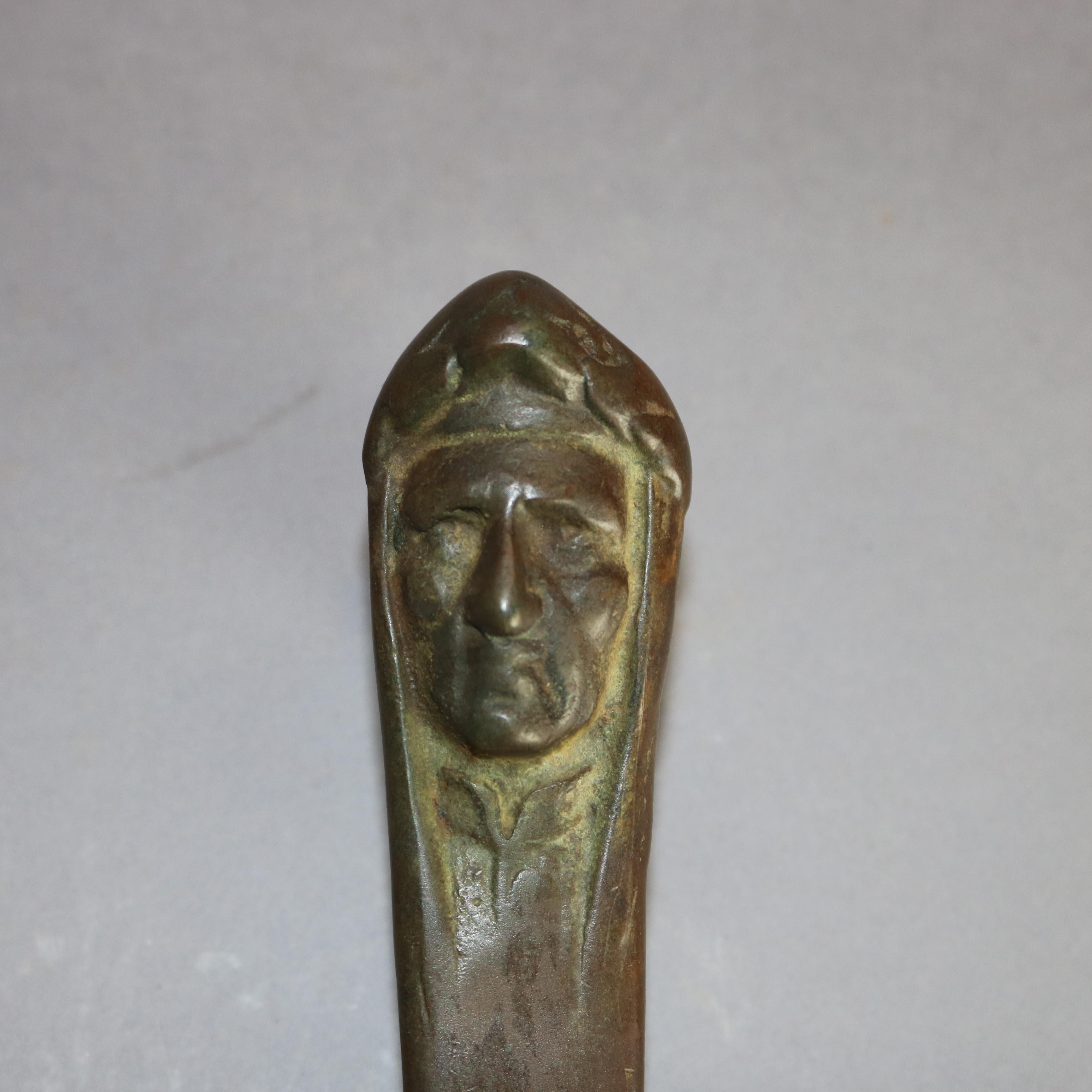 An antique letter figural letter opener in the manner Tiffany & Co. offers cast bronze construction with face mask of Italian poet Dante Alighieri, en verso later stamped as photographed, 20th century.

This item has not been authenticated and can