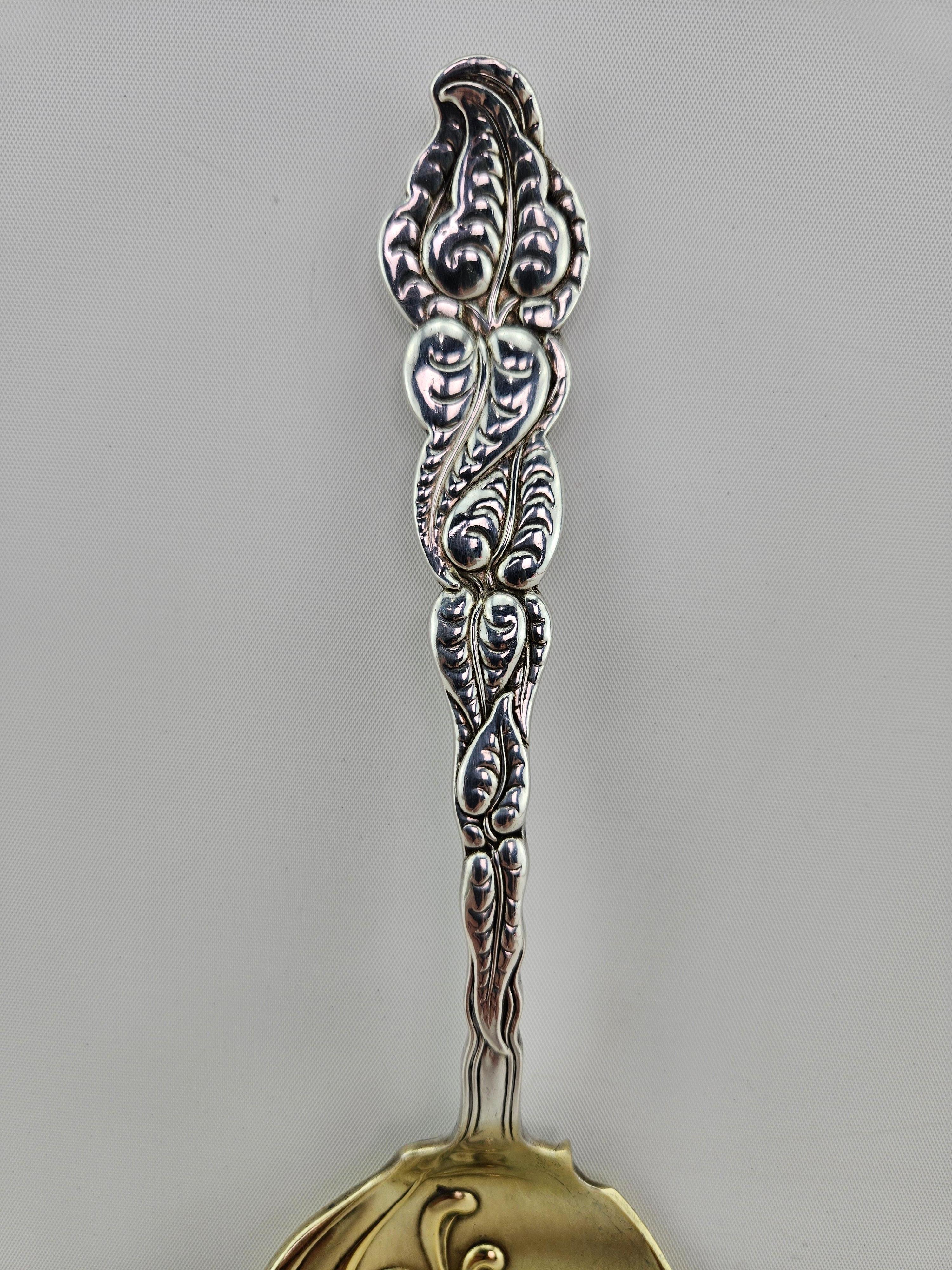 Antique Tiffany & Co. Sterling Silver Ice Cream Serving Knife.  Stamped 1899.  Highly decorative design with leaves on a vine handle.  Gold washed blade with some minor wear due to age and use.   Weighing 180 grams.