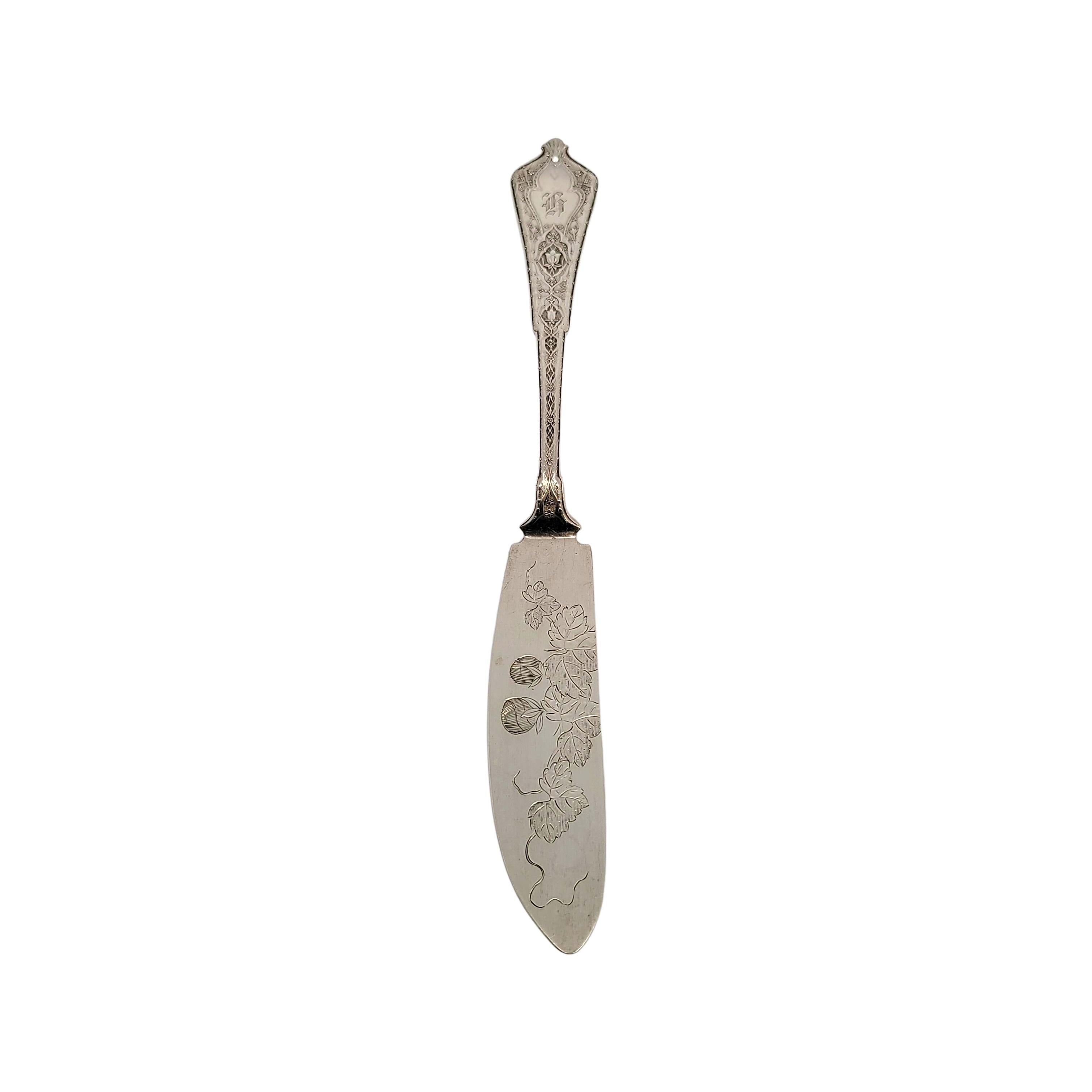 Antique Tiffany & Co sterling silver bright cut master butter knife in the Persian pattern.

Persian is an ornate pattern designed by Edward Moore. This piece features a bright cut flower and leaf design on the blade. Hallmarks date this piece to