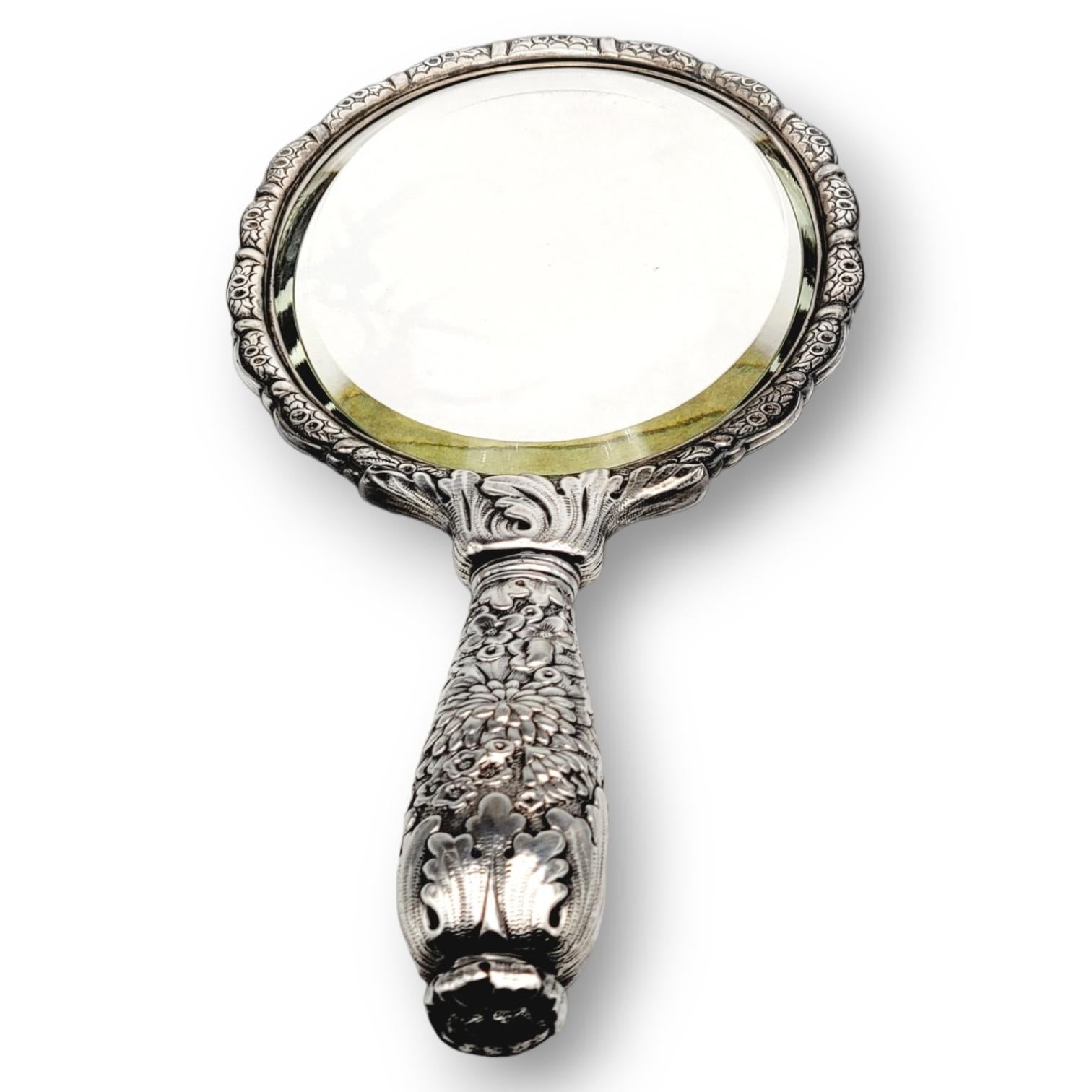 Incredibly stunning antique Tiffany & Co. hand mirror from 1870 to 1891. This exquisite piece has an intricate floral and fern repousse design covering the hand mirror from top to bottom. This mirror would be a breathtaking addition to any bedroom