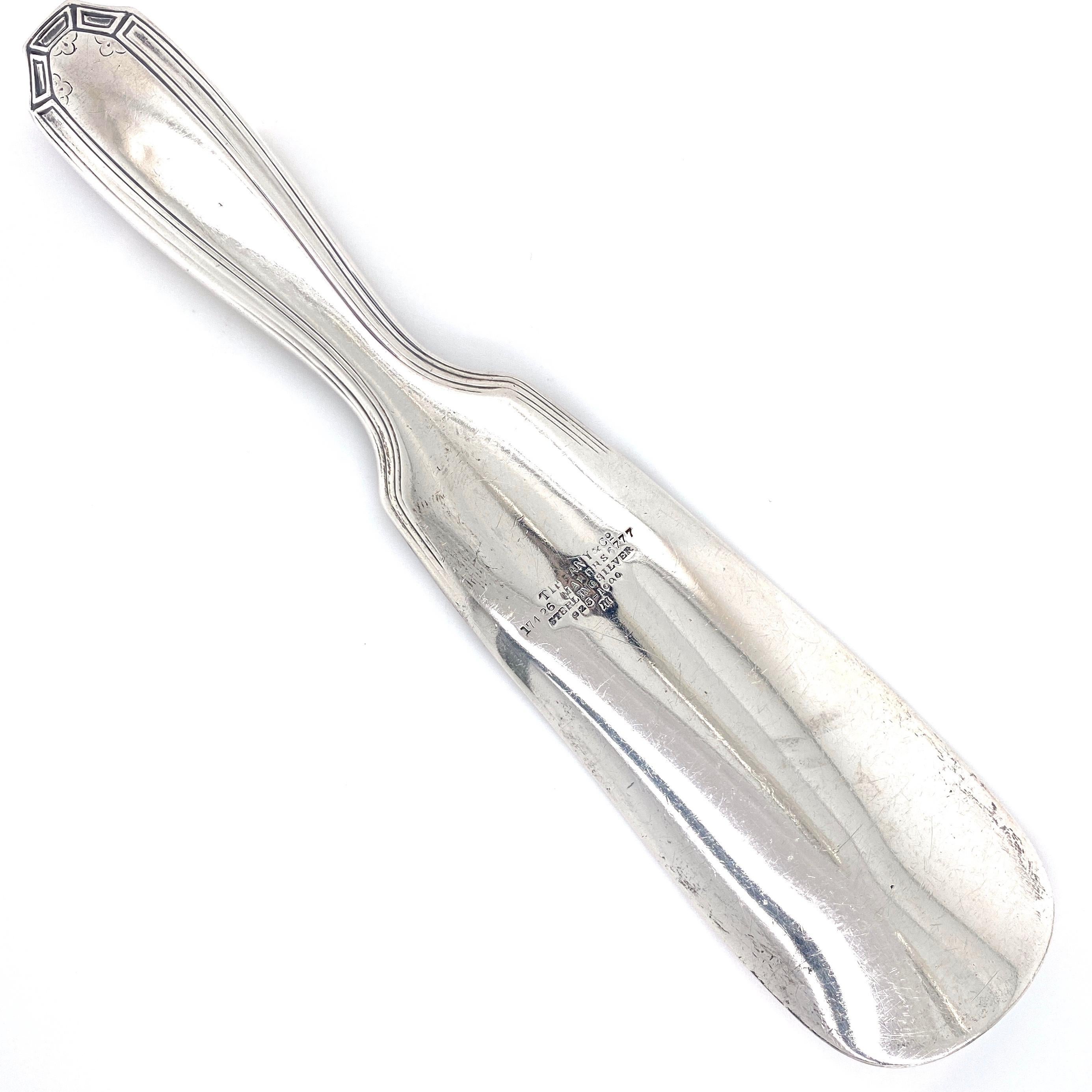 Tiffany & Co. sterling silver shoe horn. The handle is Hand engraved with geometric designs. Marked: TIFFANY & CO, 17426 MAKERS 6777, STERLING
SILVER, 925/1000.
 