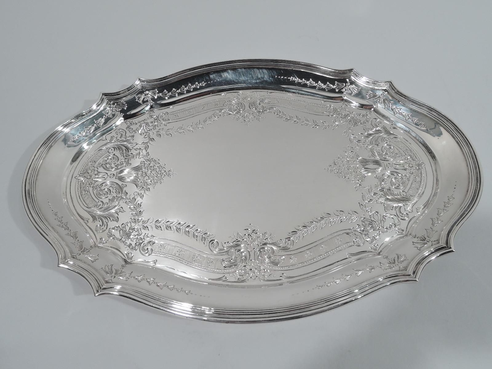 Edwardian Art Nouveau sterling silver vanity tray. Made by Tiffany & Co. in New York. Oval well with engraved flower baskets, garlands, and scrolls and shaped reeded rim. Fully marked including pattern no. 13365 (first produced in 1897) and