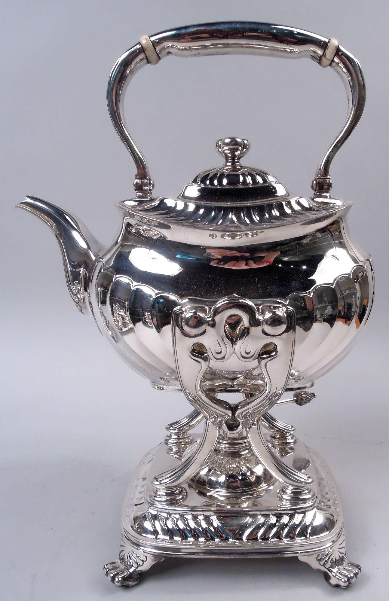 Edwardian Classical sterling silver coffee and tea set. Made by Tiffany & Co. in New York. This set comprises six pieces: Hot water kettle on stand, coffeepot, teapot, creamer, sugar, and waste bowl. Embossed armorial shields (vacant) between