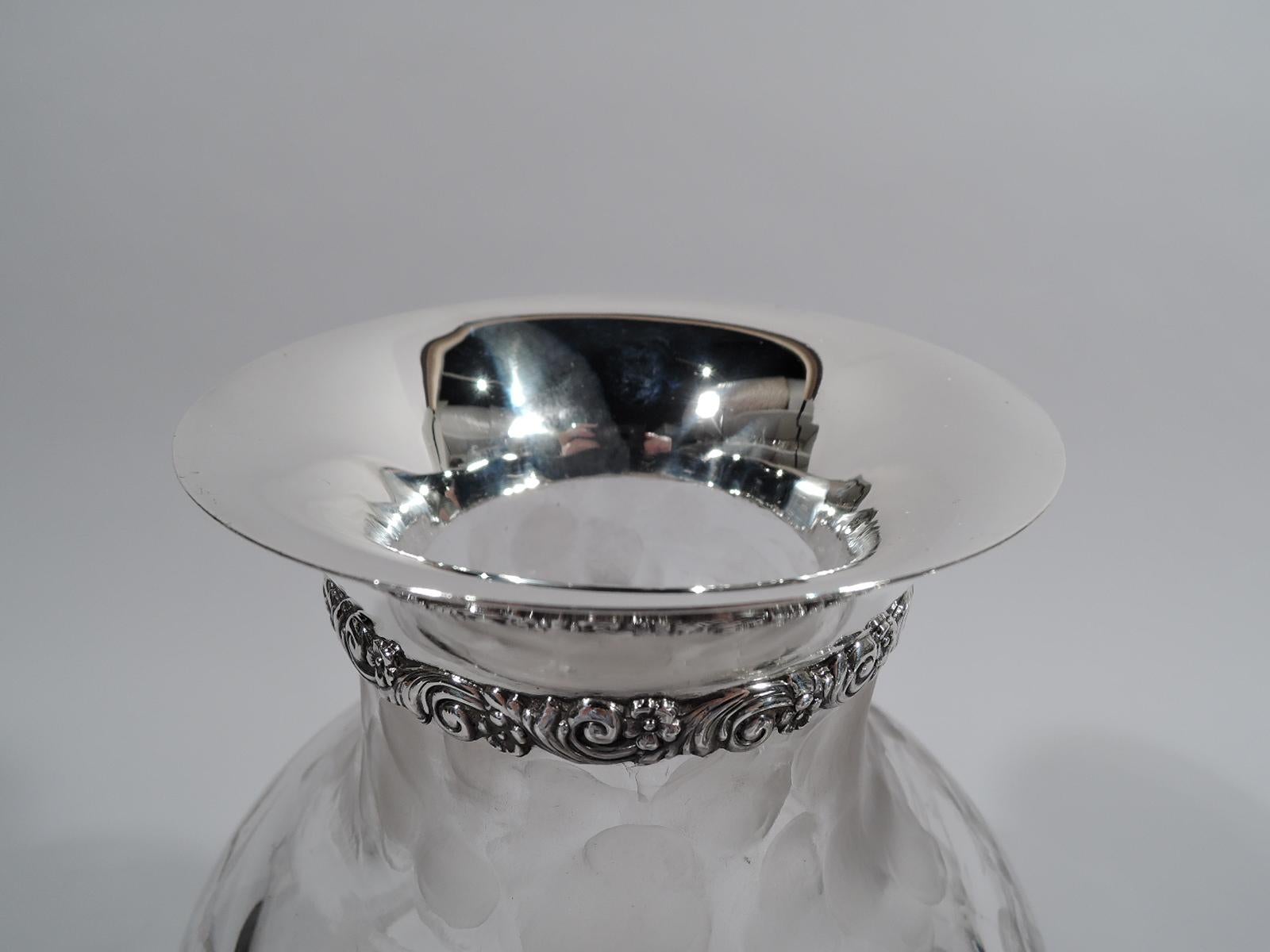 Turn-of-the-century glass vase with sterling silver collar. Made by Tiffany & Co. in New York. Clear with acid-etched birds soaring above a marshy landscape with cattails and grass. A crane spots a frog, which dives into the water in