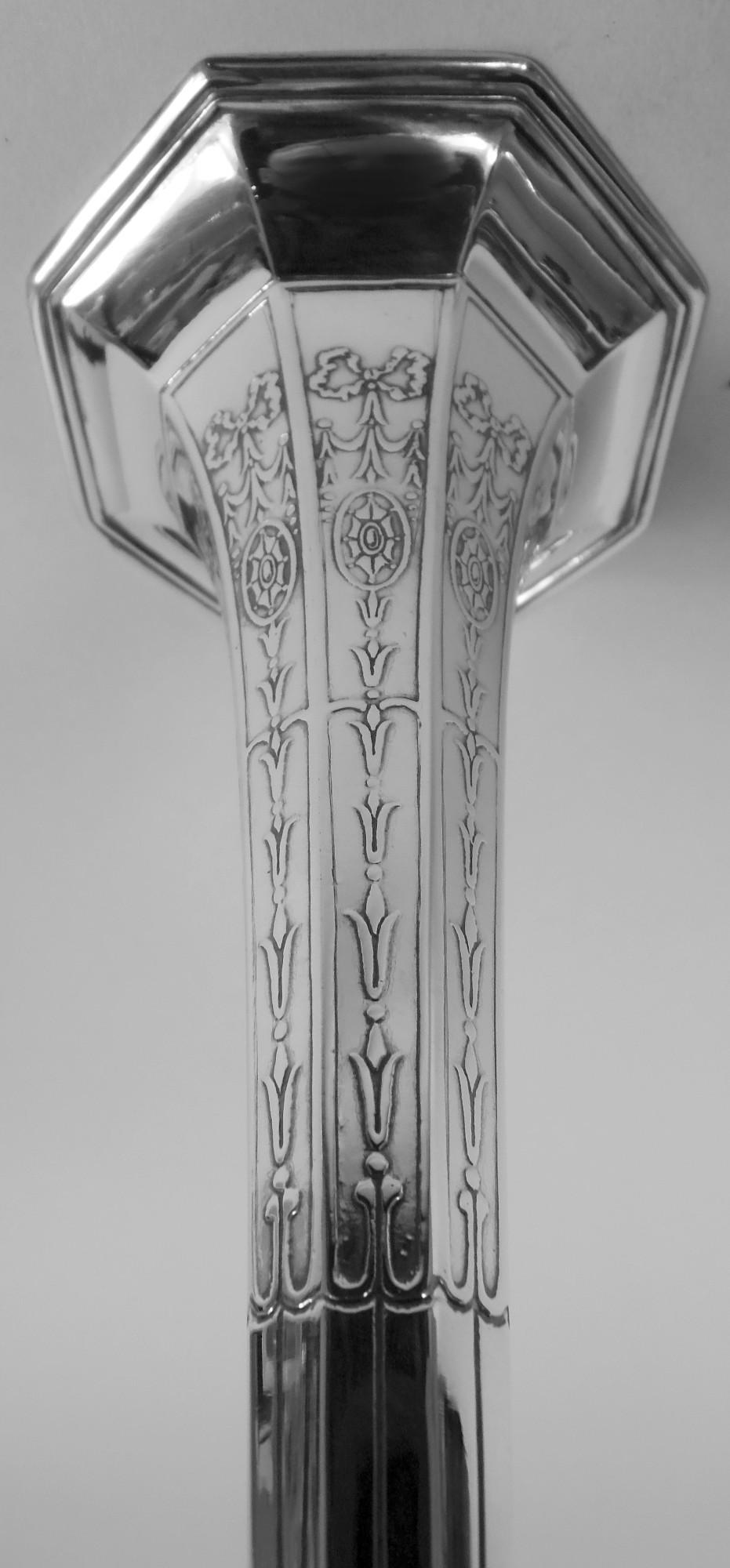 Edwardian Regency bud vase. Made by Tiffany & Co. in New York, ca 1912. Conical with flared mouth and raised foot. Faceted. An early design in the emerging geometric style with acid-etched stylized ornament: Fluting and ribboned pendant flowers and