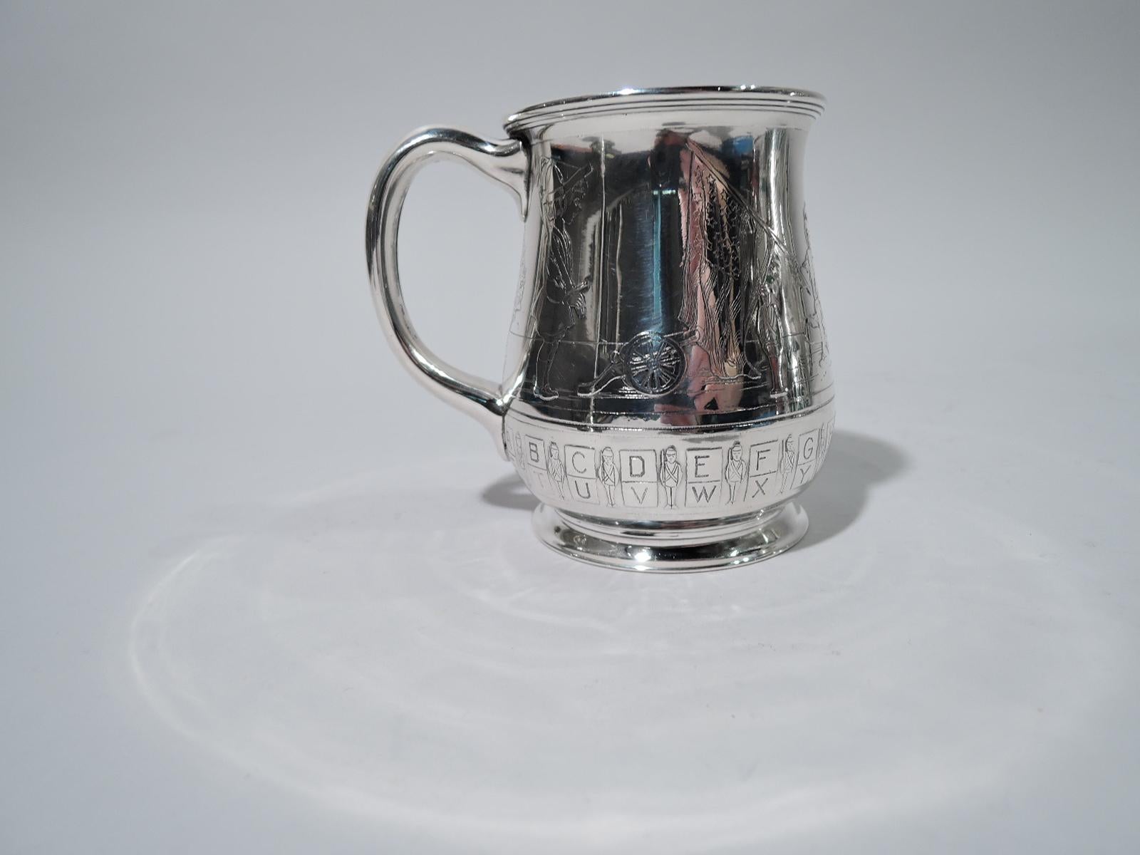 Edwardian sterling silver baby cup. Made by Tiffany & Co. in New York, circa 1910. Curved body with flared rim, C-scroll handle, and raised foot. Acid-etched scene depicting a patriotic assembly, with one child holding a sword, another waving a