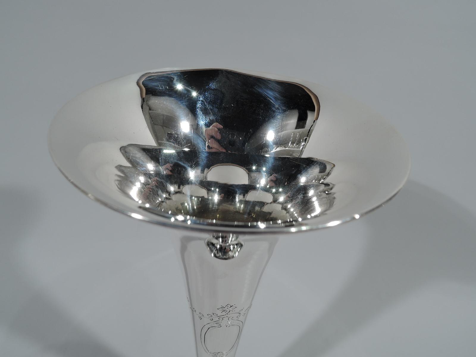 Edwardian sterling silver trumpet vase. Made by Tiffany & Co. in New York, ca 1912. Conical with flared mouth and base knop flowing into gently raised foot. Engraved ornament: Two scrolled oval frames (vacant) with garland and pendant flowers on