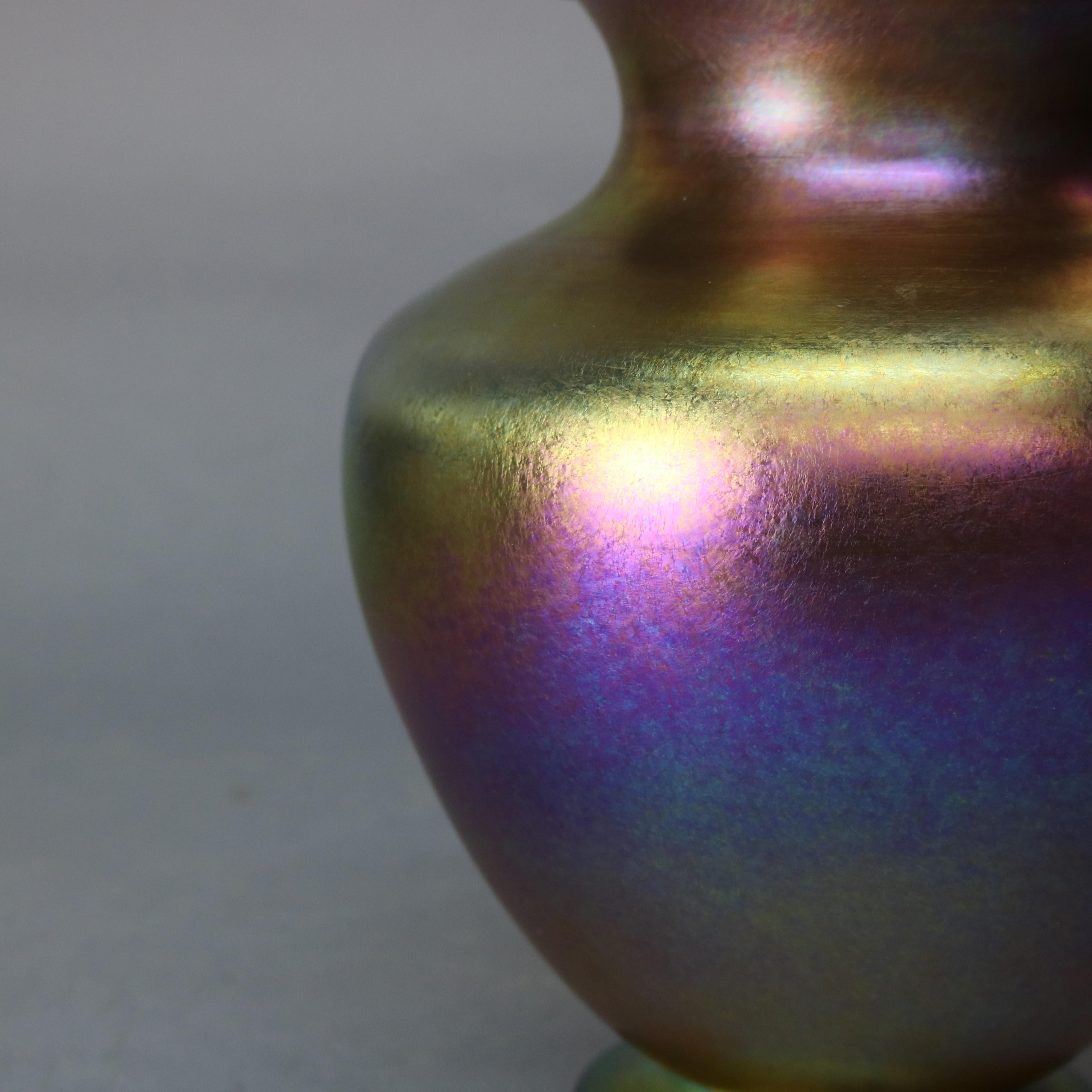 An antique vase by L.C. Tiffany offers Gold Favrile art glass construction with bulbous form and flared lip, signed on base L. C. Tiffany #2580, circa 1910

Measured: 10.5