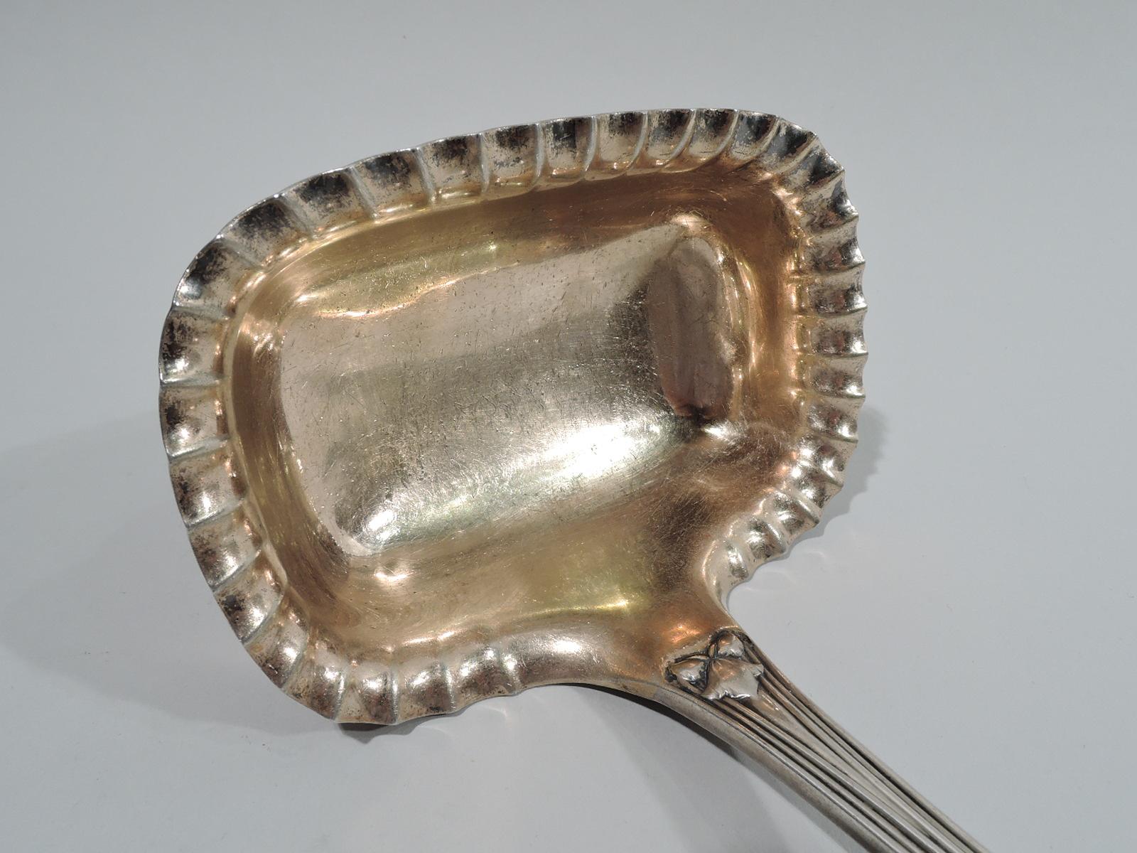 Japanese sterling silver soup ladle. Made by Tiffany & Co in New York. Oval terminal with double-sided low-relief stylized ornament: Perched bird, flowers, leafing stalks, and cattails. Interlaced monogram on verso. Reed handle. Rectangular gilt