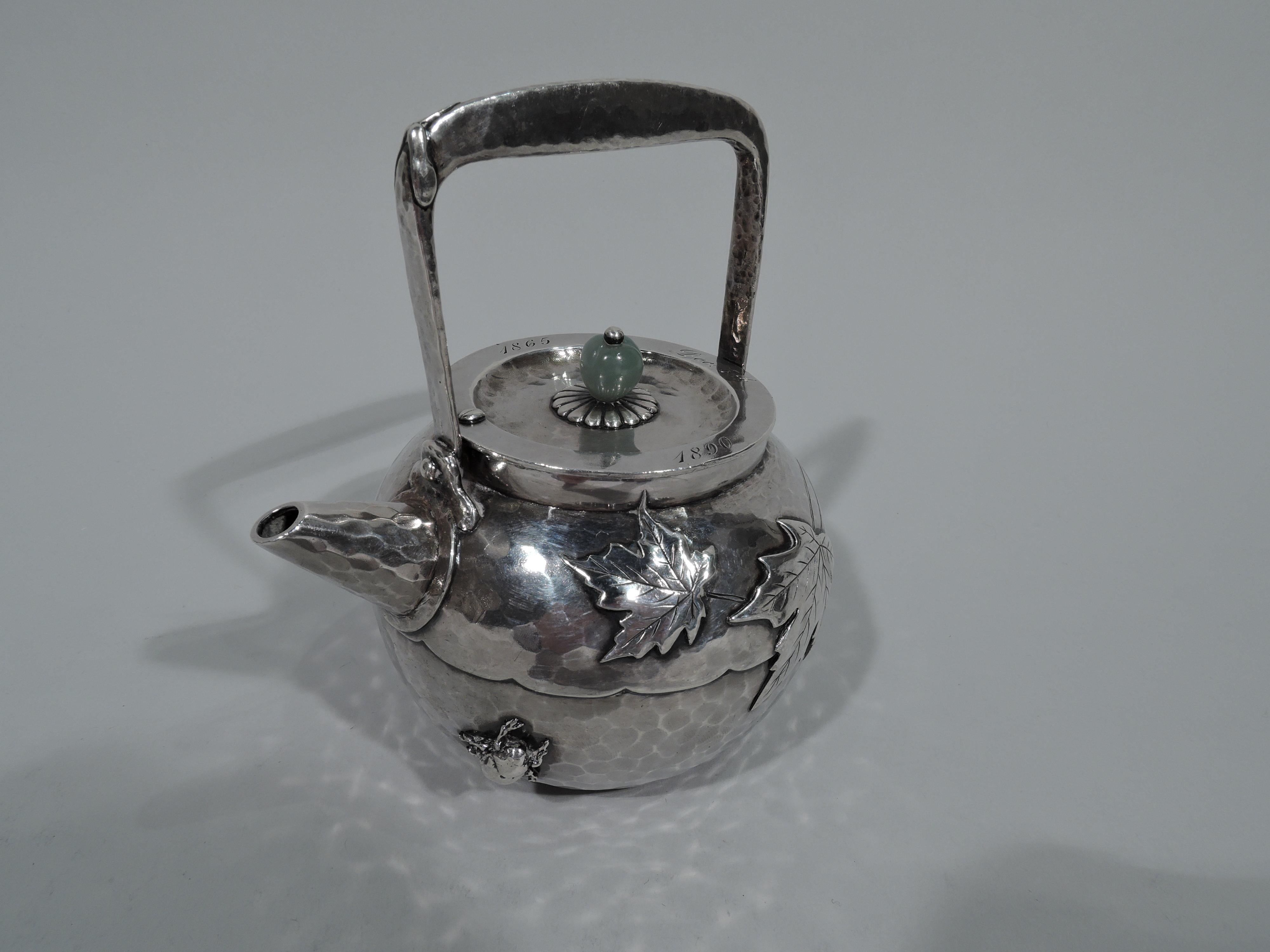Japonesque sterling silver sake pot. Made by Tiffany & Co. in New York, circa 1880. Globular with short and tapering diagonal spout and stationary bracket handle. Cover inset with jade bead finial on petal mount. Allover honeycomb hand hammering.