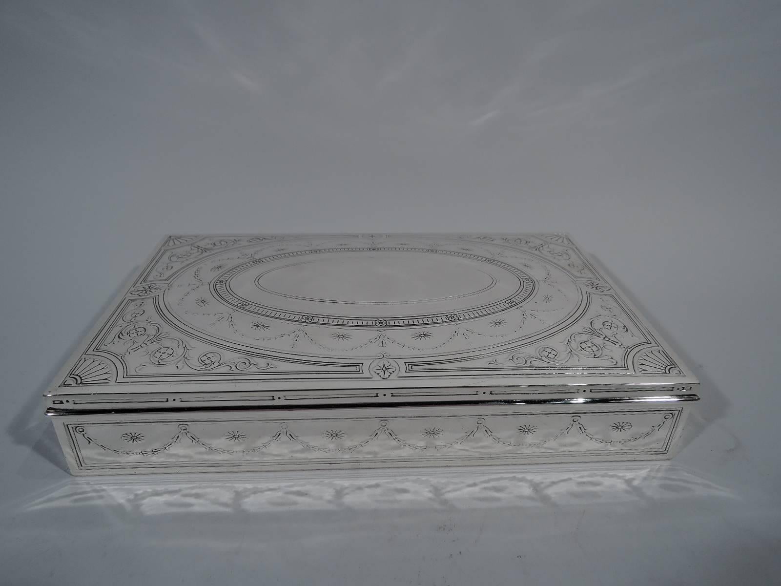 Neoclassical sterling silver desk box. Made by Tiffany & Co. in New York, circa 1913. Rectangular with curved and hinged cover. Raised ornament including garlands, dentil, and paterae on sides and cover. On cover is central oval cartouche (vacant).