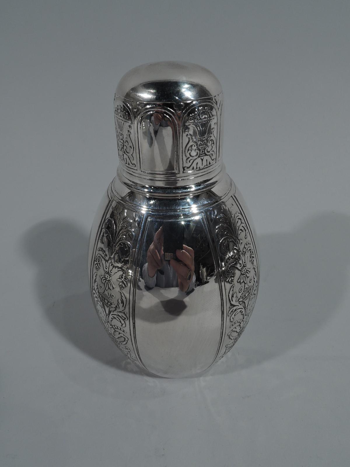 Renaissance-Revival sterling silver tea caddy. Made by Tiffany & Co. in New York, circa 1910. Ovoid with short neck and snug-fitting cover. Vertical ornament in form of alternating wide plain bands and narrow acid-etched ones with Grotesque