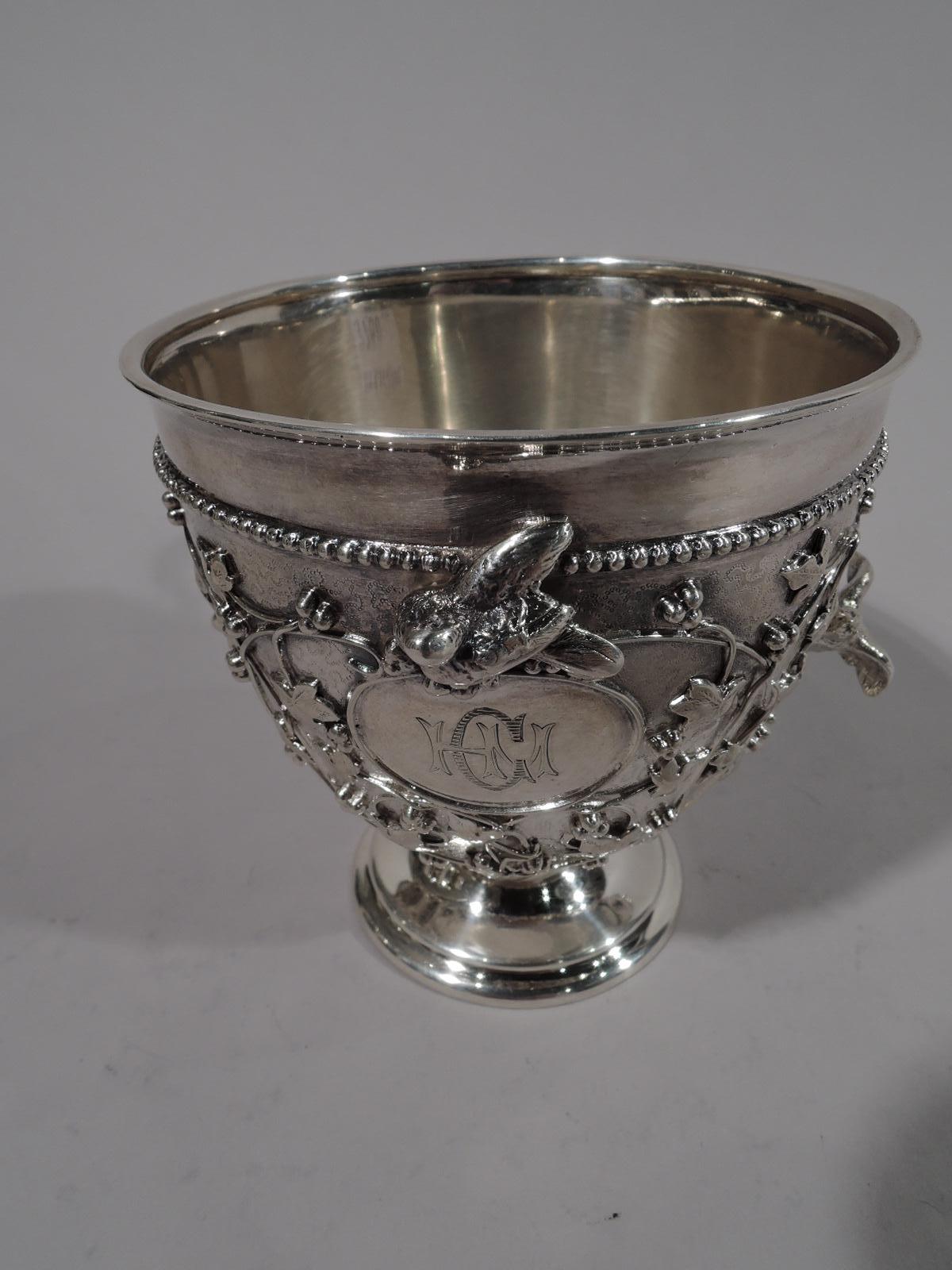 Finest quality sterling silver baby cup in rare Bird’s Nest pattern. Made by John C. Moore & Son for Tiffany & Co. in New York, circa 1865-1870. Ovoid bowl on stepped foot. Scroll handle with squiggle tail. Bowl has shaped pointille ornament and