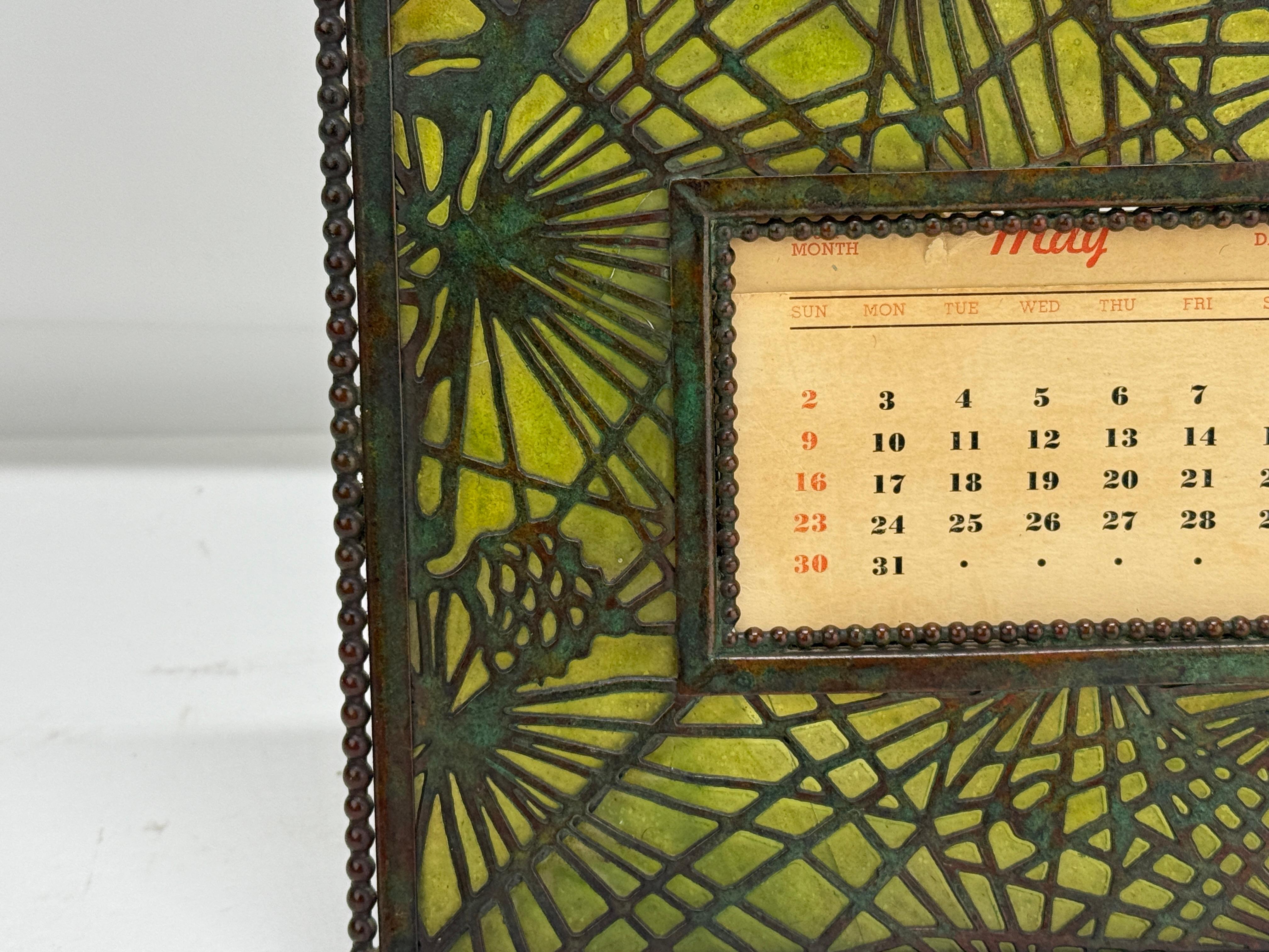 This exquisite desk calendar, produced by Tiffany Studios in the early 20th century, features the iconic 