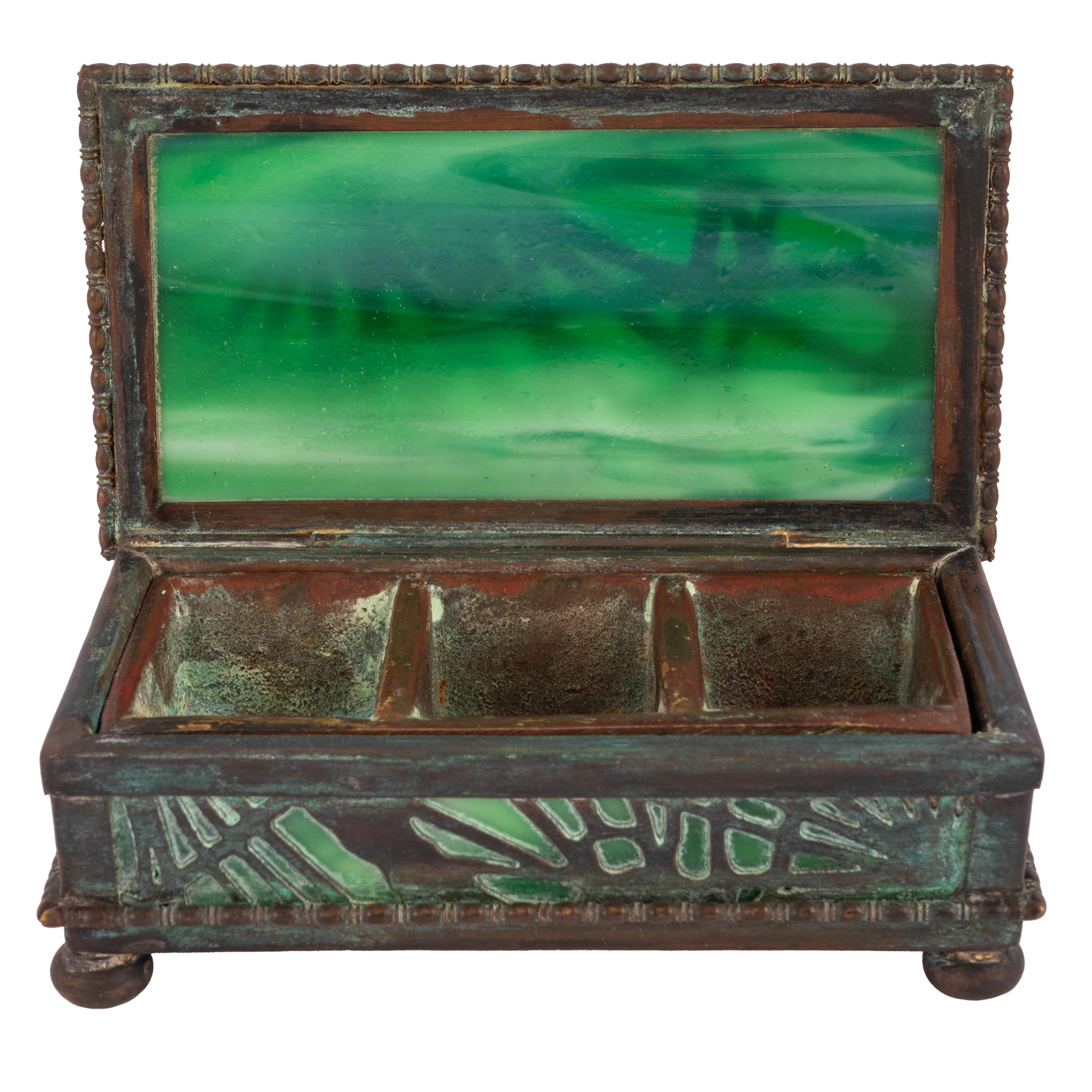 Antique Art Nouveau Tiffany & Co bronze and slag glass 'Pine Needles' desk set stamp box, circa 1910.
The box with a hinged lid and containing the original liner for storing stamps, the box lined with a vibrant green iridescent slag glass. The box