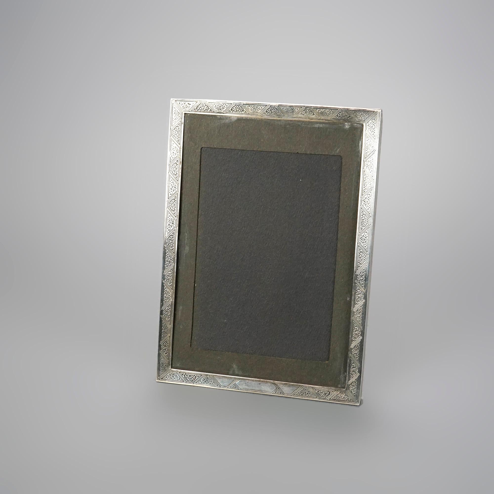 An antique picture frame by Tiffany Studios offers sterling silver construction with embossed geometric design, maker signed, c1900

Measures- 9.25''H x 6.5''W x .5''D.